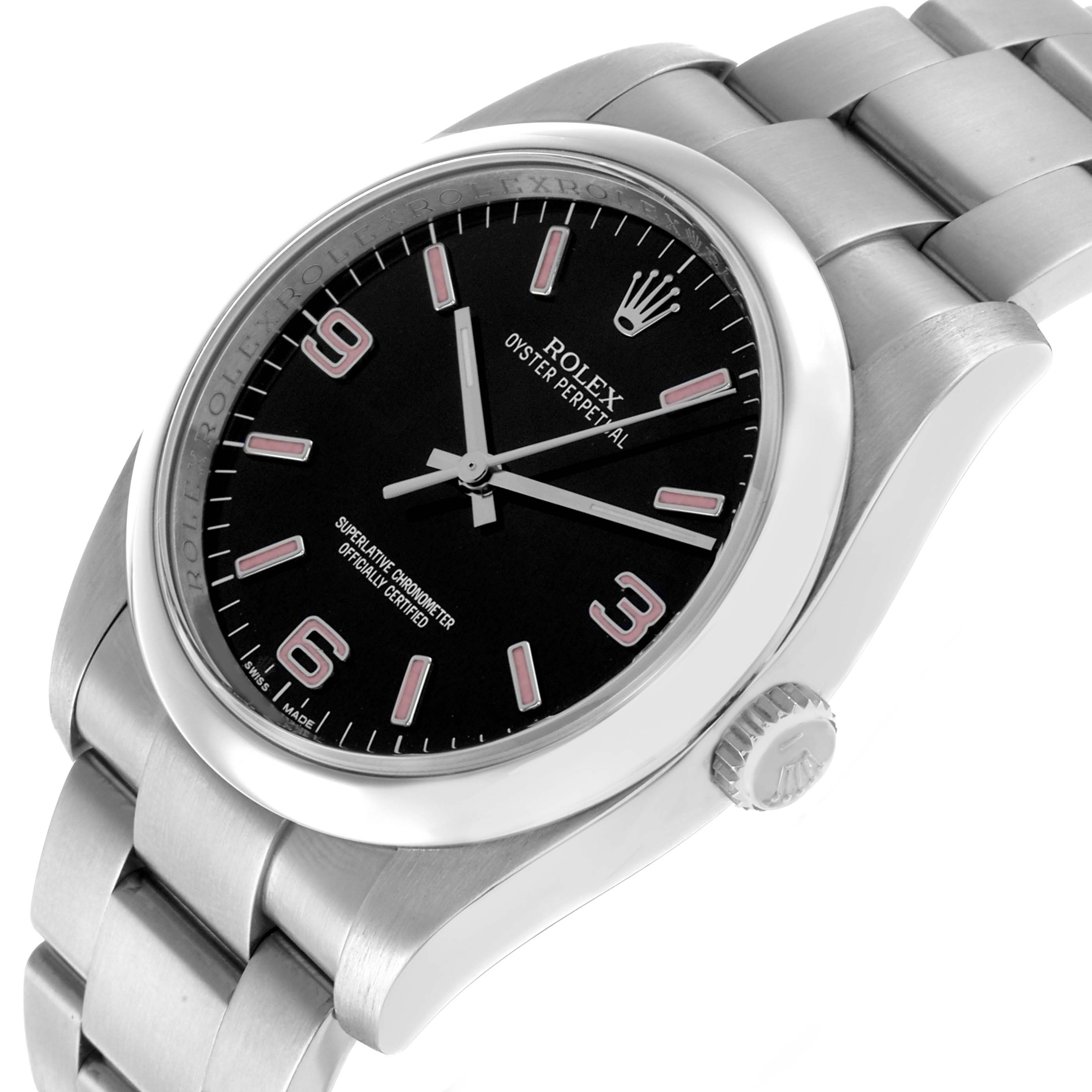 The Rolex Oyster Perpetual 116000 Men's Stainless Steel Black Dial watch is shown at an angled view, highlighting the black dial, crown, and stainless steel bracelet.