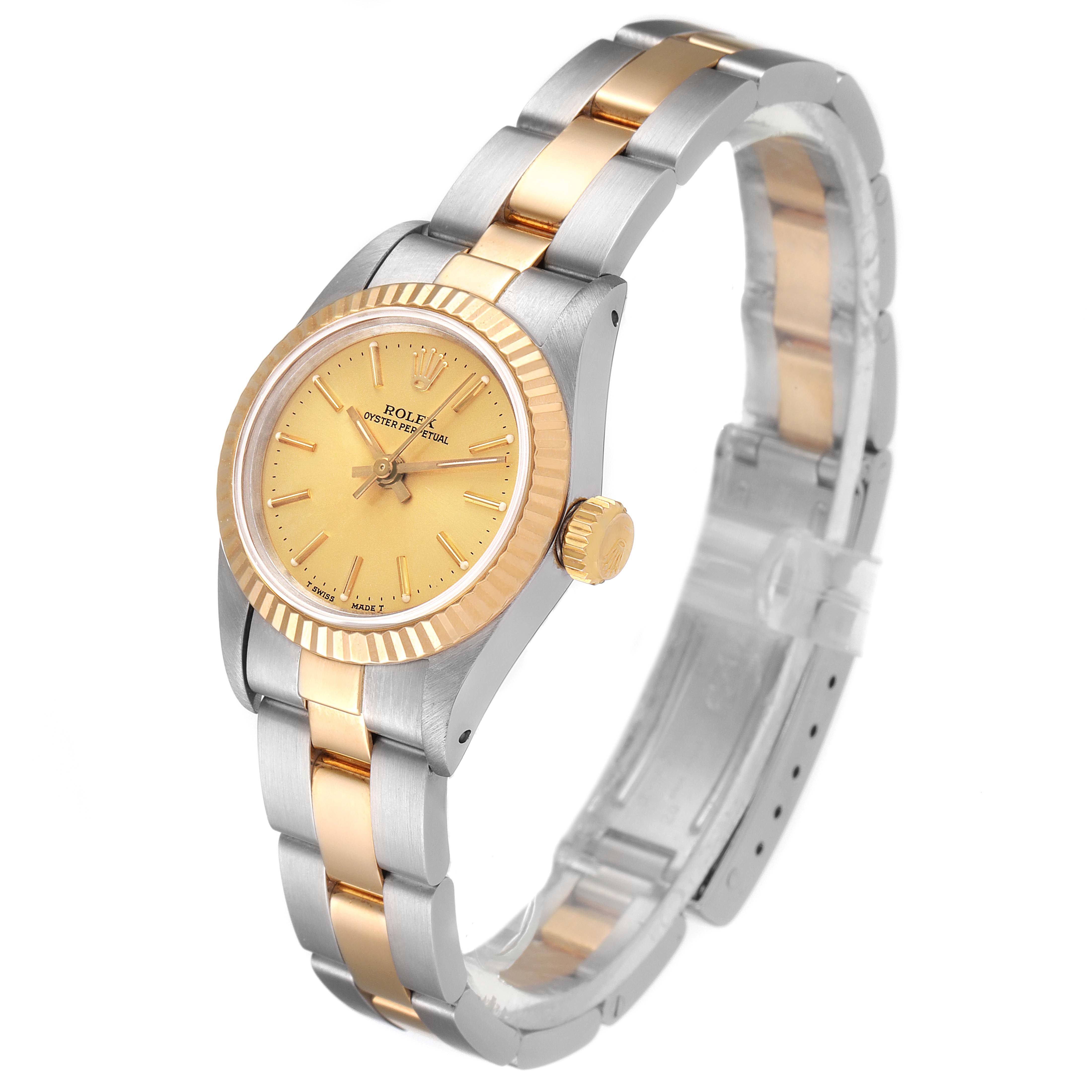 This image shows a Rolex Oyster Perpetual 67193 Women's Steel and Gold (two tone) Champagne Dial 67193 Women's Steel and Gold (two tone) Champagne Dial watch at an angle highlighting the face, crown, and two-tone bracelet.