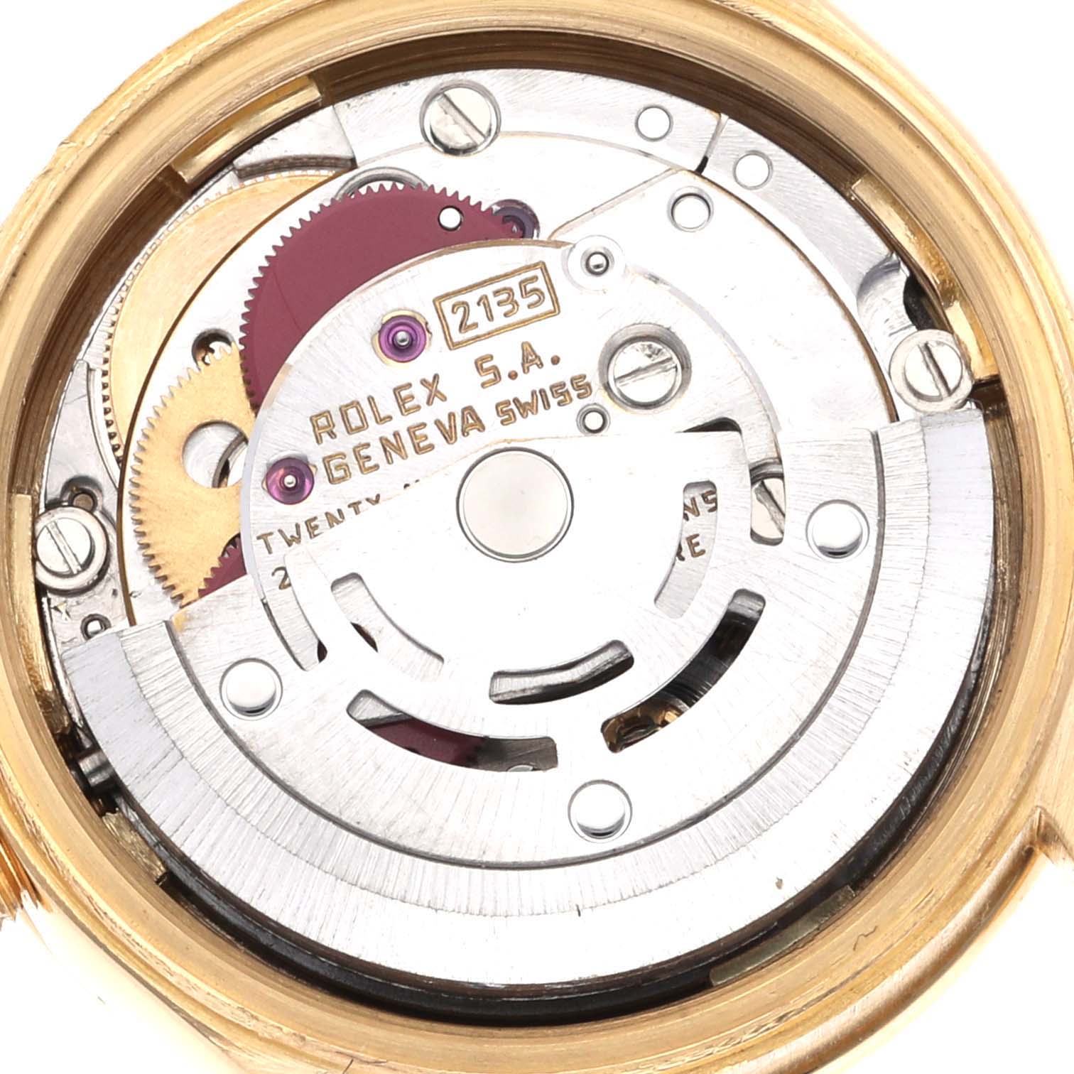 The image shows a close-up view of the movement inside a Rolex Datejust watch, highlighting the rotor and gears.