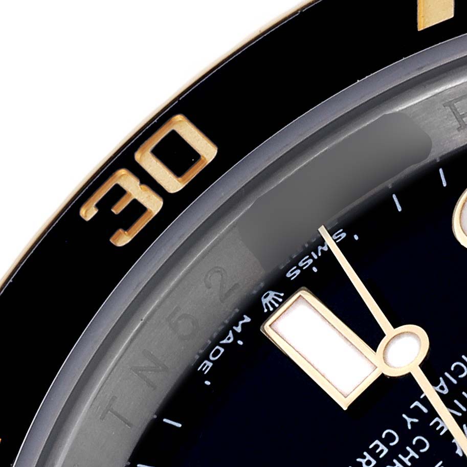 The image shows a close-up of the bezel and dial of a Rolex Submariner 126613LN Men's Steel and Gold (two tone) Black Dial 126613LN Men's Steel and Gold (two tone) Black Dial, highlighting the 30-minute marker and watch hands.