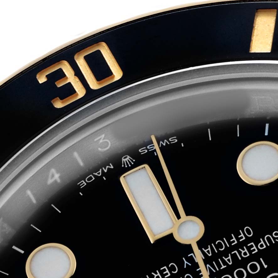 The image shows the dial and bezel of a Rolex Submariner 126613 Men's Steel and Gold (two tone) Black Dial watch, highlighting the 30-minute mark and luminescent indices.