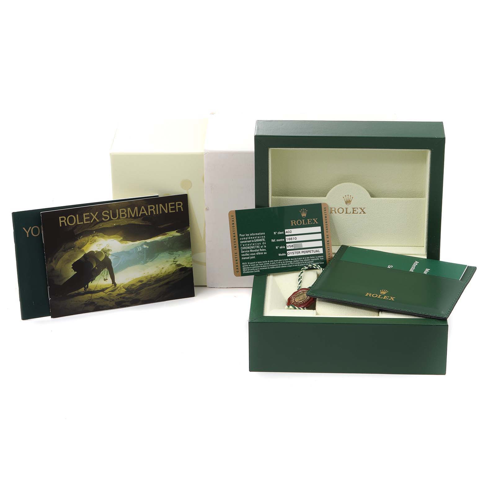 The image shows the Rolex Submariner 16610 Men
s Stainless Steel Black Dial 16610 Men
s Stainless Steel Black Dial packaging, including the inner and outer boxes, manuals, warranty card, and accessories.