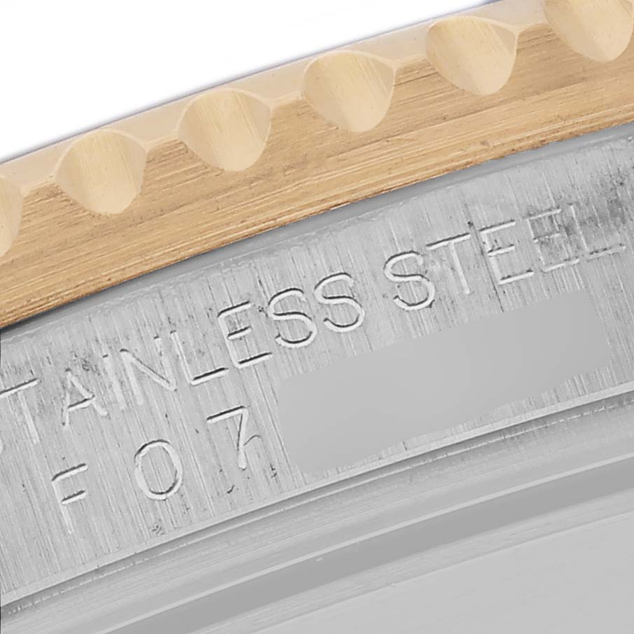 The image shows a close-up of the bezel and case edge of a Rolex Submariner 16613 Men's Steel and Gold (two tone) Blue Dial 16613 Men's Steel and Gold (two tone) Blue Dial, highlighting the stainless steel and engraving.