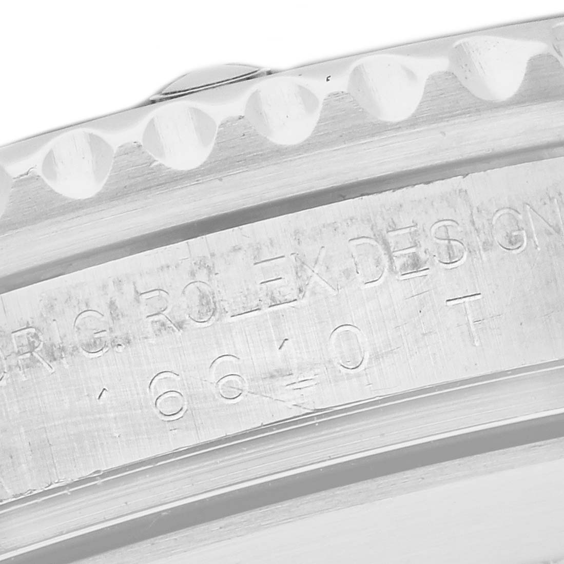 The image shows a close-up of the engraved bezel edge of a Rolex Submariner 16610 Men
s Stainless Steel Black Dial 16610 Men
s Stainless Steel Black Dial watch.