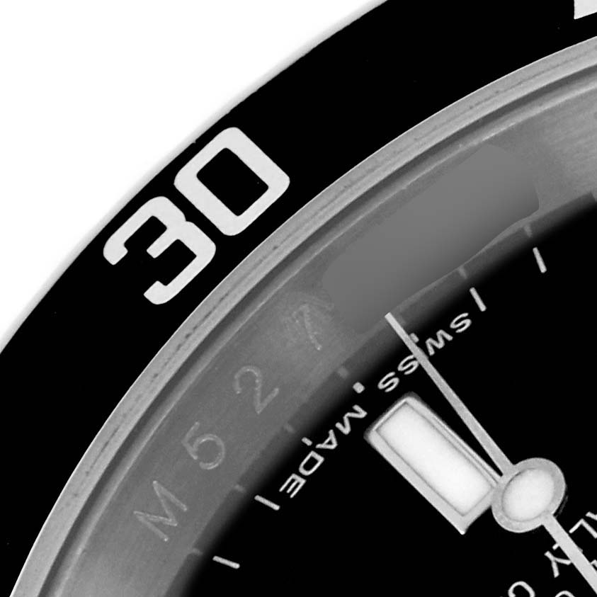 This image shows a close-up of the bezel and a portion of the dial of the Rolex Submariner 16610 Men
s Stainless Steel Black Dial 16610 Men
s Stainless Steel Black Dial watch.