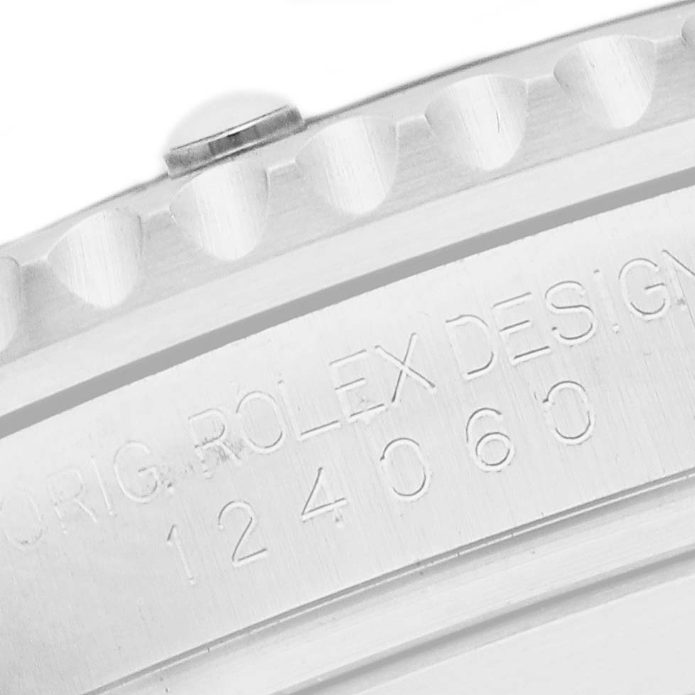 The image shows a close-up of the bezel and engraved case of a Rolex Submariner 124060 Men's Stainless Steel Black Dial.