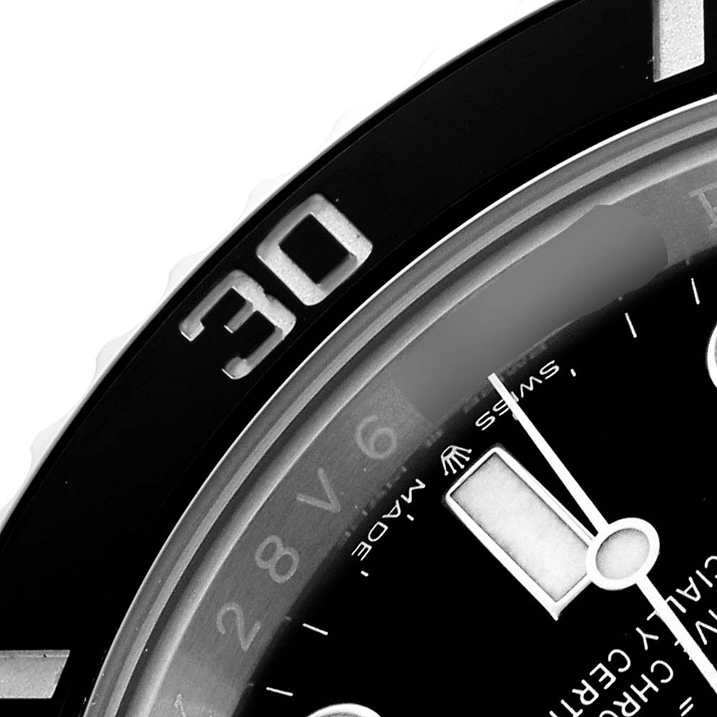 The image shows a close-up of the Rolex Submariner 124060 Men's Stainless Steel Black Dial watch face, focusing on the bezel's 30-minute mark and part of the dial.