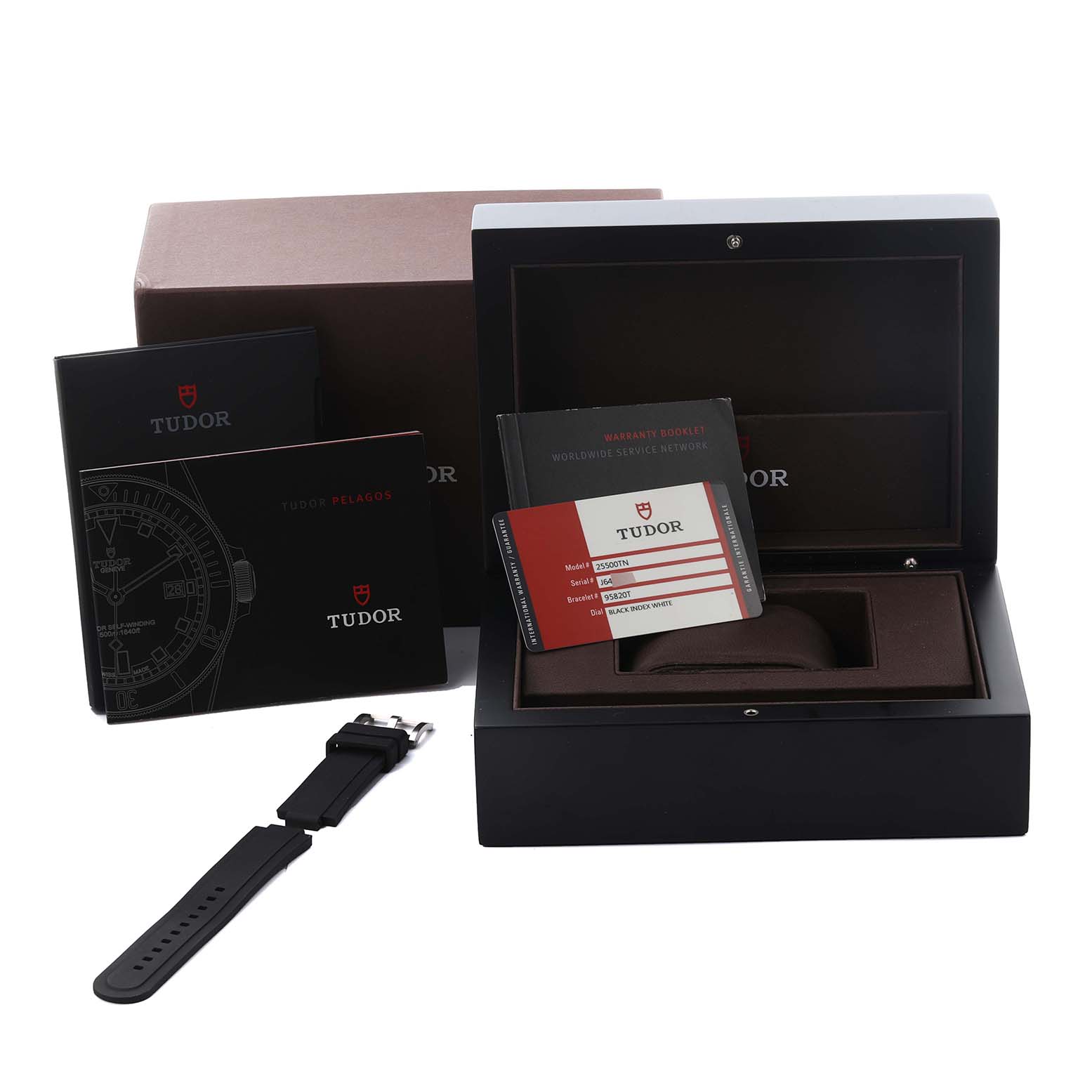 The image shows a Tudor Pelagos 25500TN Men
s Titanium Black Dial 25500TN Men
s Titanium Black Dial watch box, manuals, warranty card, and an extra strap from a front angle.