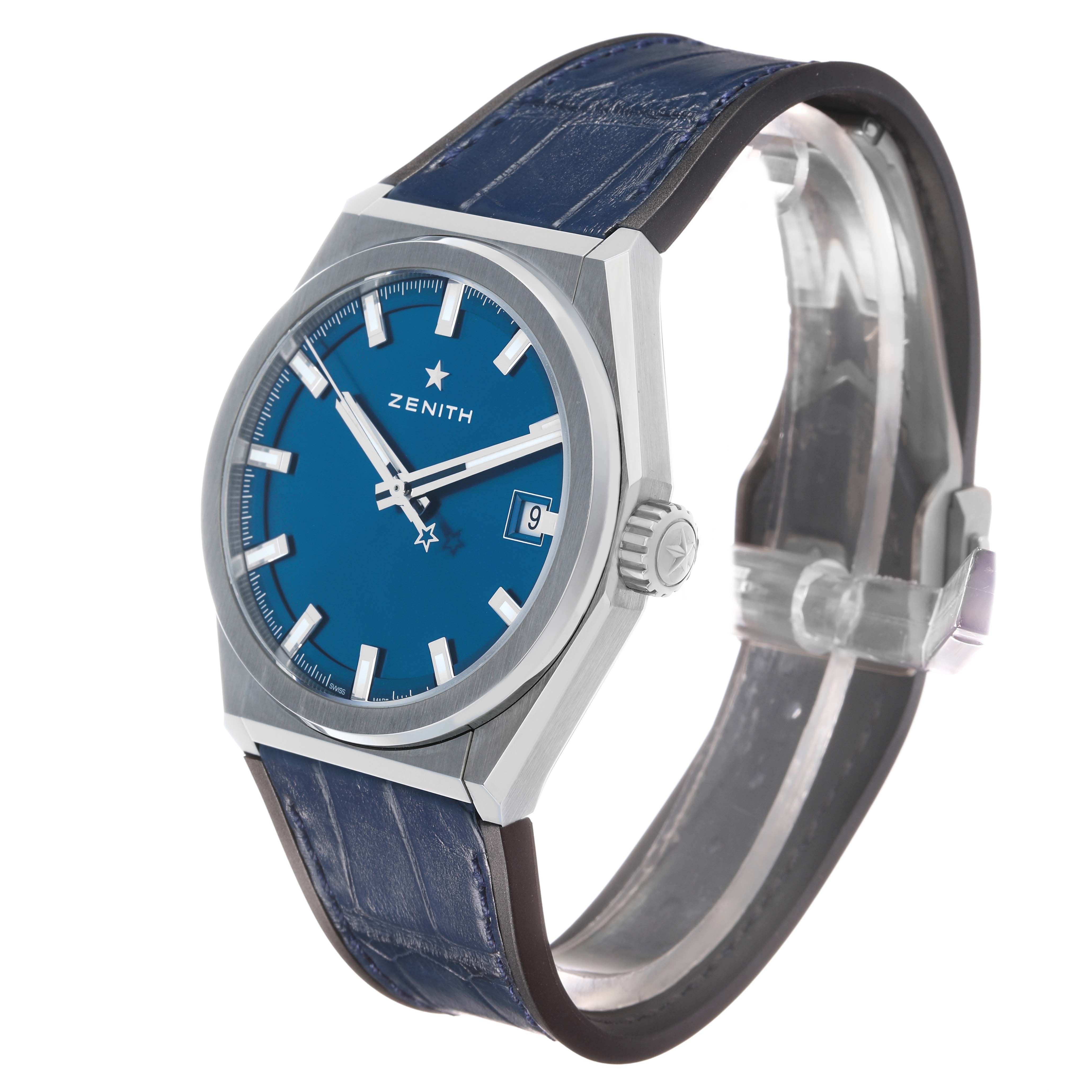 The Zenith Defy 95.9000.670/51 Men's Titanium Blue Dial watch is shown at a three-quarter angle, displaying the blue dial, crown, date window, and strap.