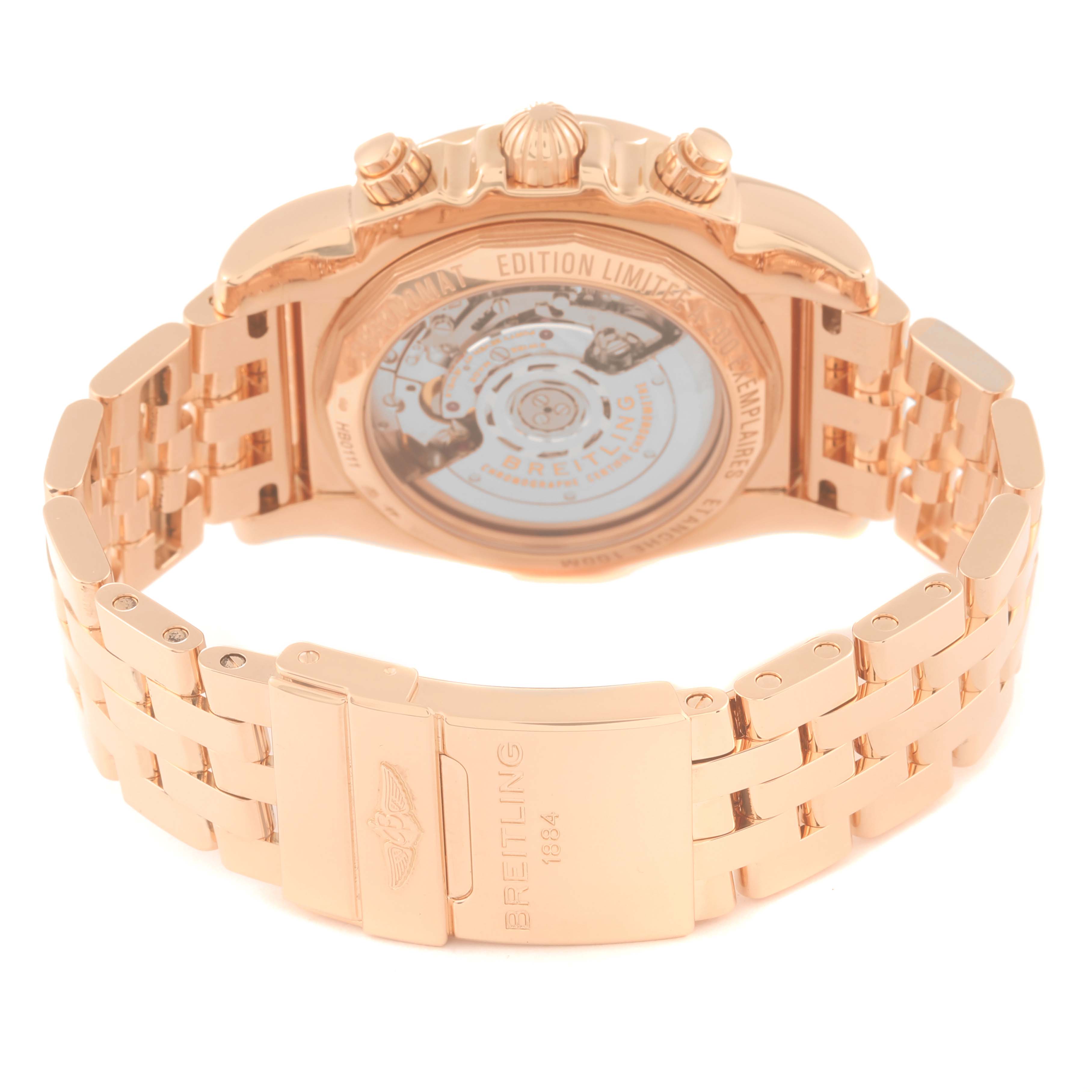 The image shows the back and clasp of the Breitling Chronomat HB011112/BA51 Men's Rose Gold Black Dial HB011112/BA51 Men's Rose Gold Black Dial watch, highlighting its gold bracelet and transparent case back.