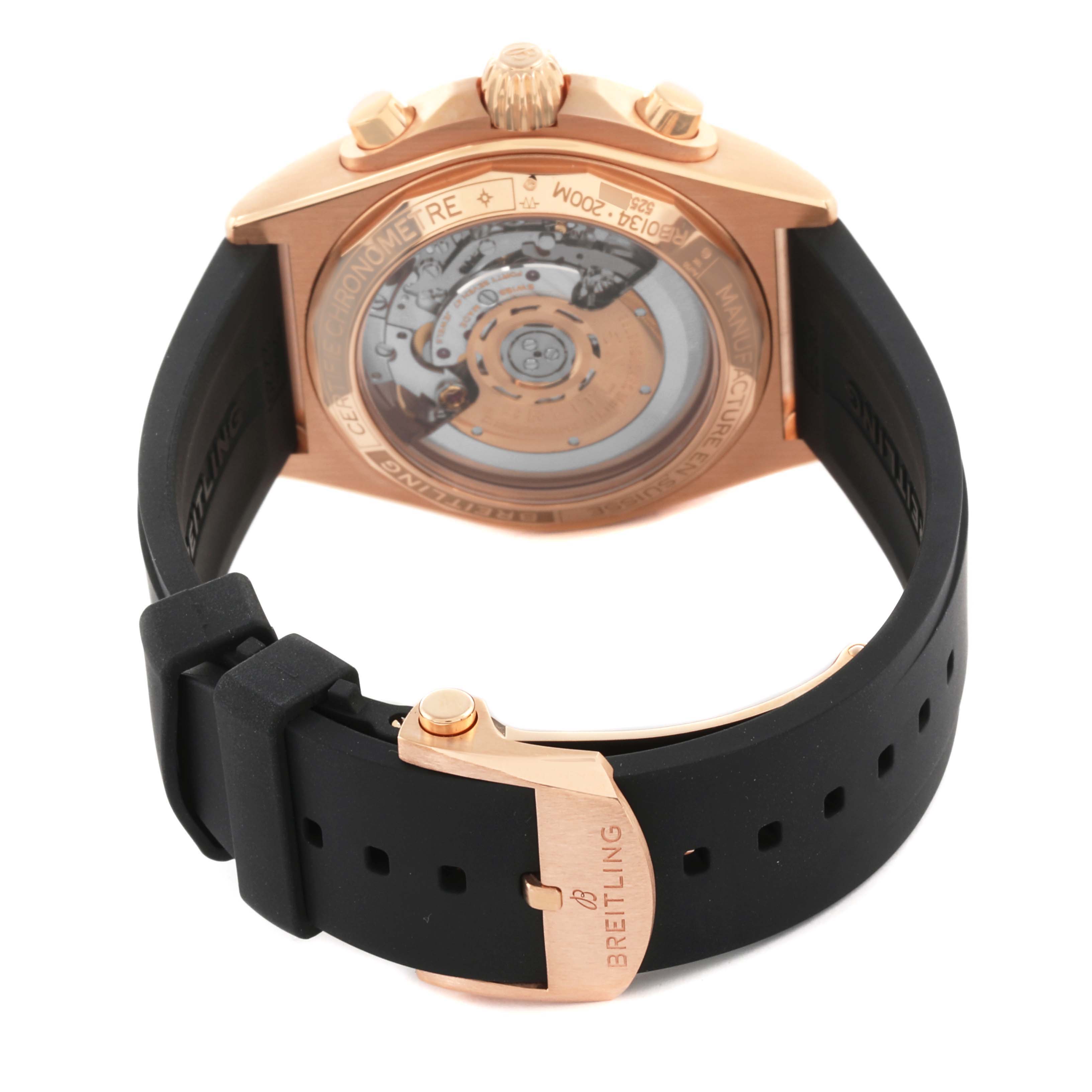 The image shows the back of a Breitling Chronomat RB0134 Men's Rose Gold Grey Dial RB0134 Men's Rose Gold Grey Dial watch, highlighting its open caseback and black strap with a rose gold clasp.