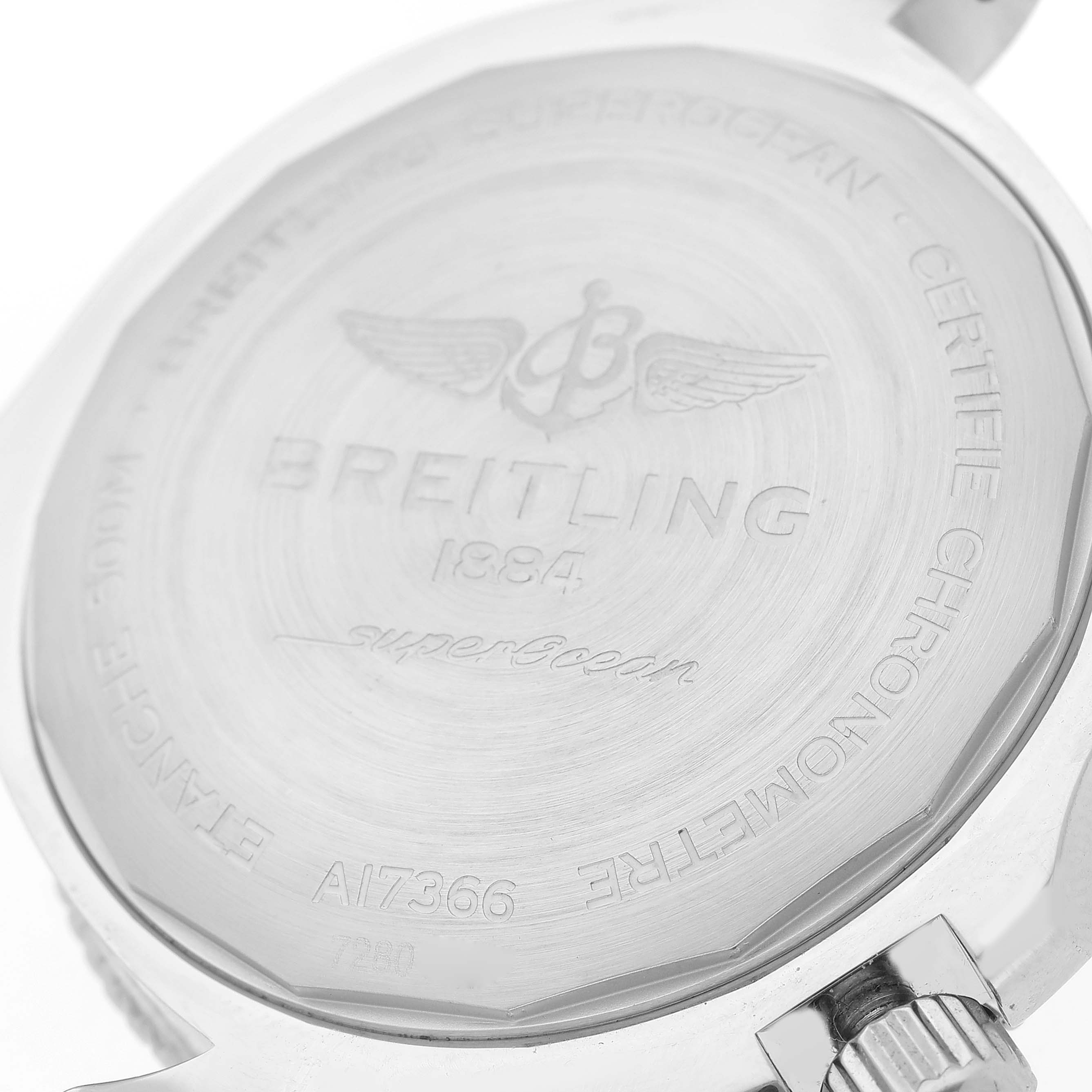 The image shows the back of a Breitling Superocean A17366 Men's Stainless Steel White Dial A17366 Men's Stainless Steel White Dial watch, highlighting its engravings and crown.
