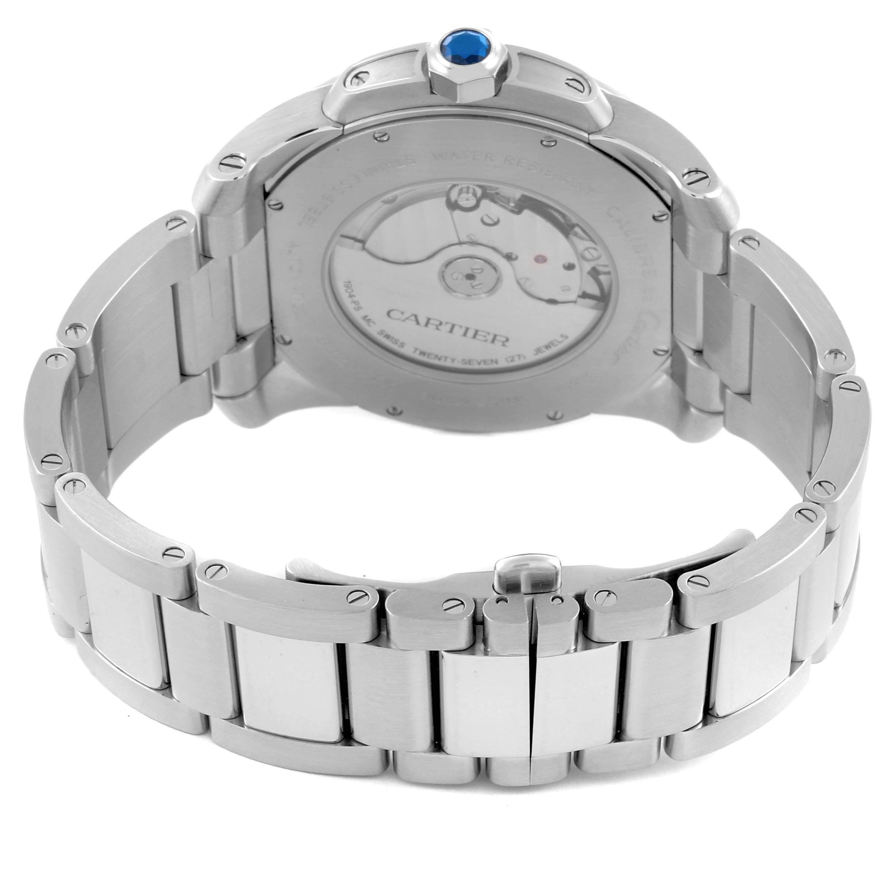 The image shows the back of a Calibre de Cartier watch, highlighting the transparent case back and metal bracelet.