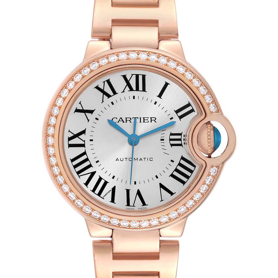 The Cartier Ballon Bleu watch is shown from the front, highlighting the diamond bezel and the signature crown.