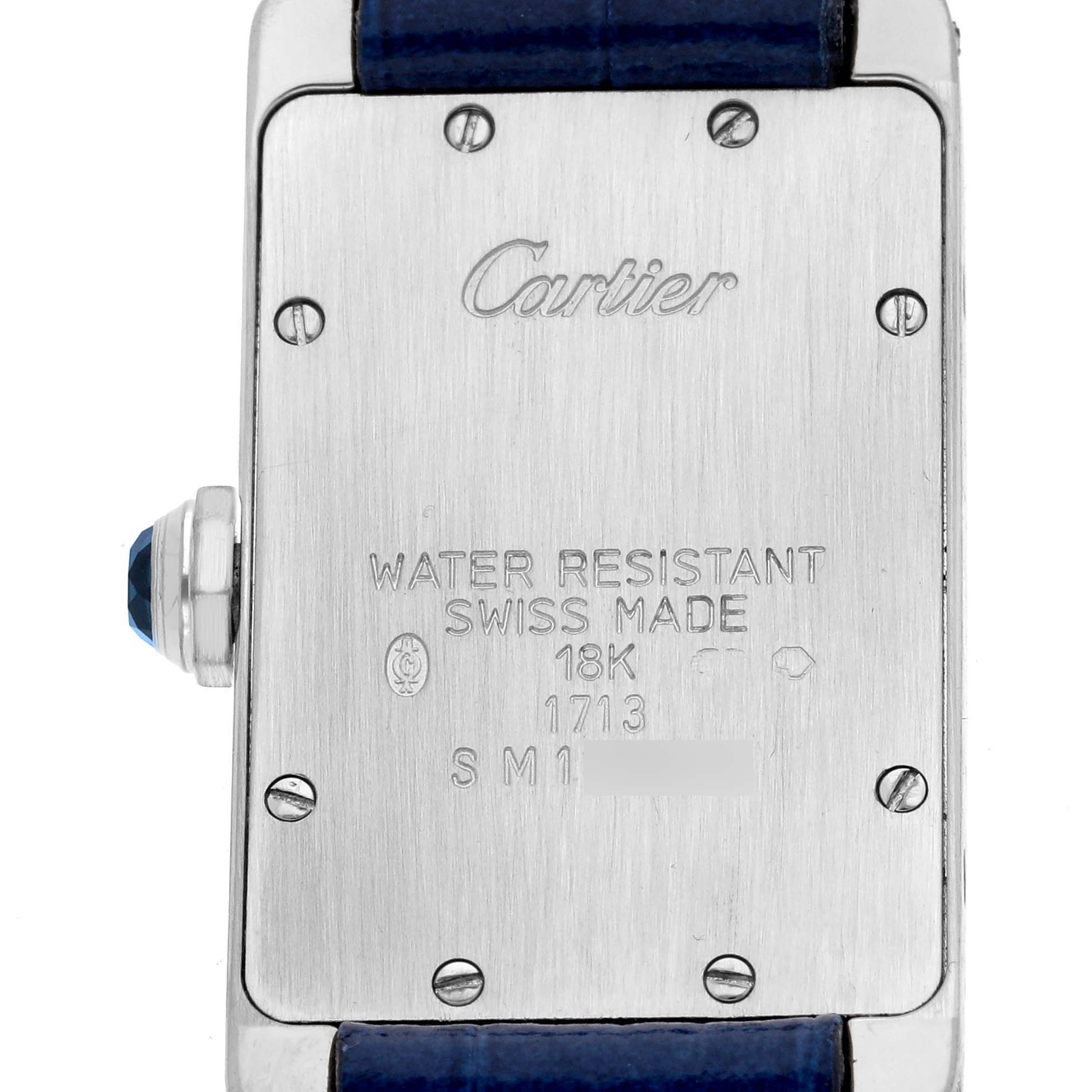 The image shows the back case of the Cartier Tank Americaine W2601956 Women's White Gold Silver Dial W2601956 Women's White Gold Silver Dial watch, featuring engravings and a visible crown.