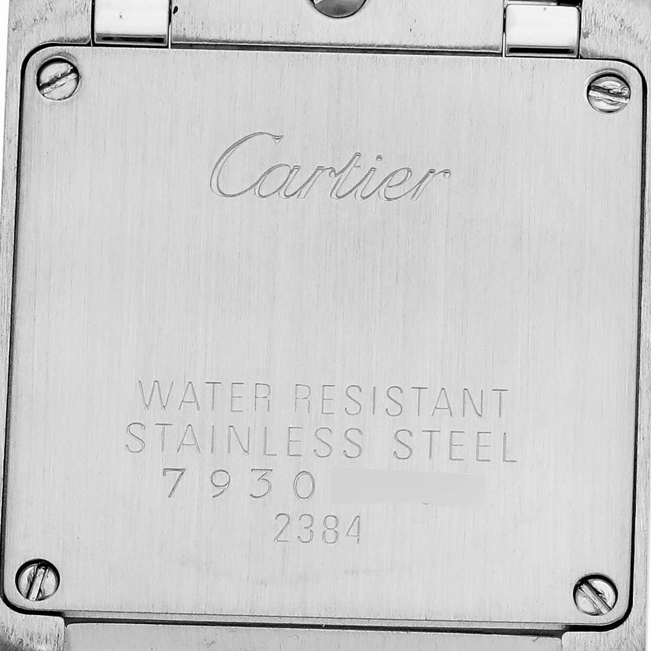 The image shows the engraved back case of the Cartier Tank Française watch.