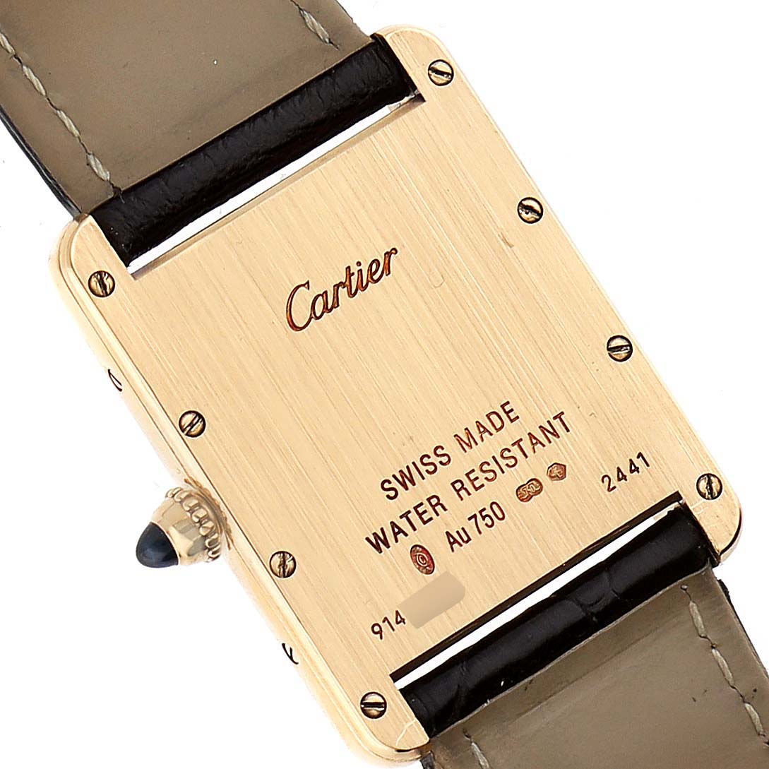 This image shows the back case of a Tank Louis watch by Cartier, displaying the brand and model engraving.