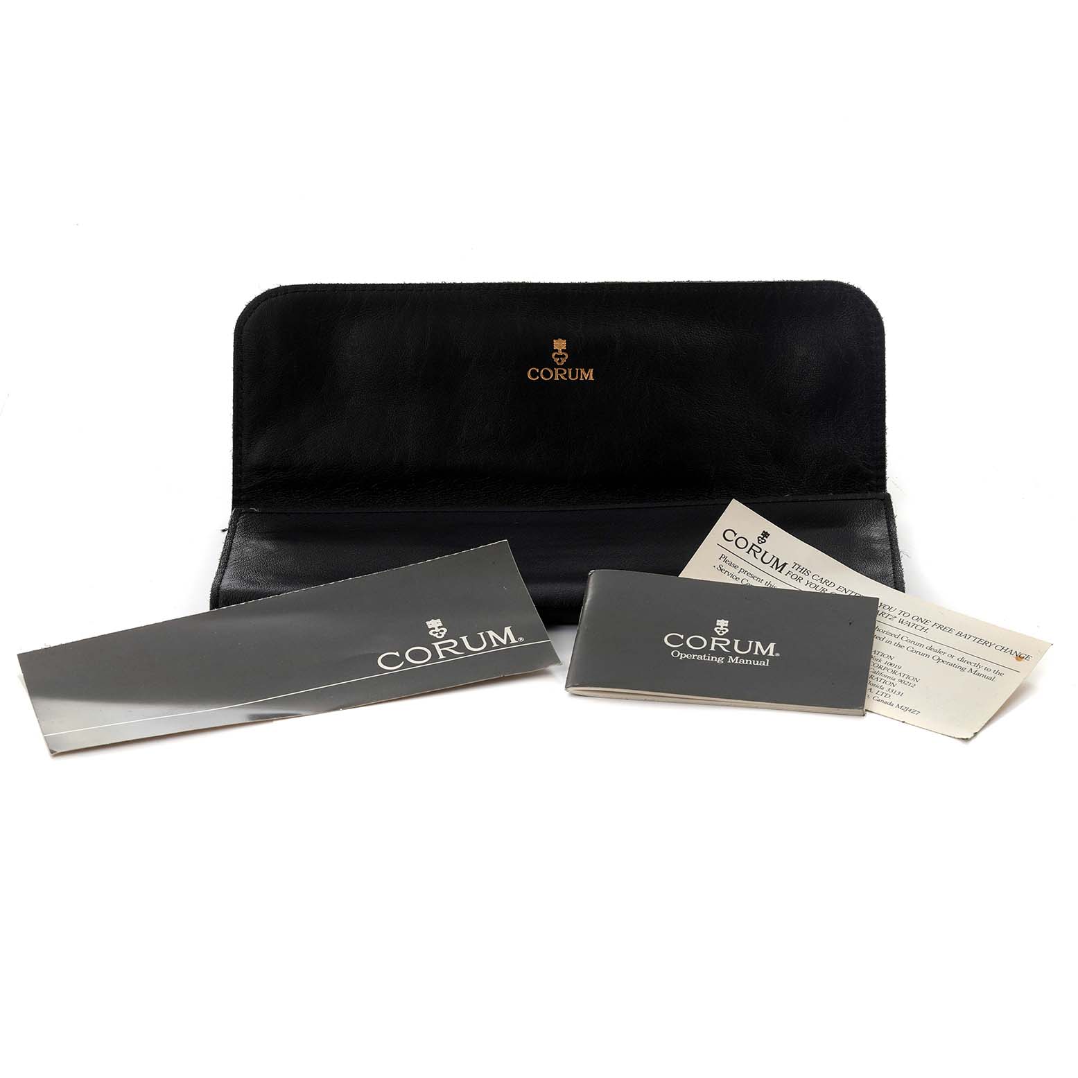 The image shows Corum Coin Watch 1903 Men's Yellow Gold Yellow Dial 1903 Men's Yellow Gold Yellow Dial accessories, including a leather case and manuals, laid out on a flat surface.