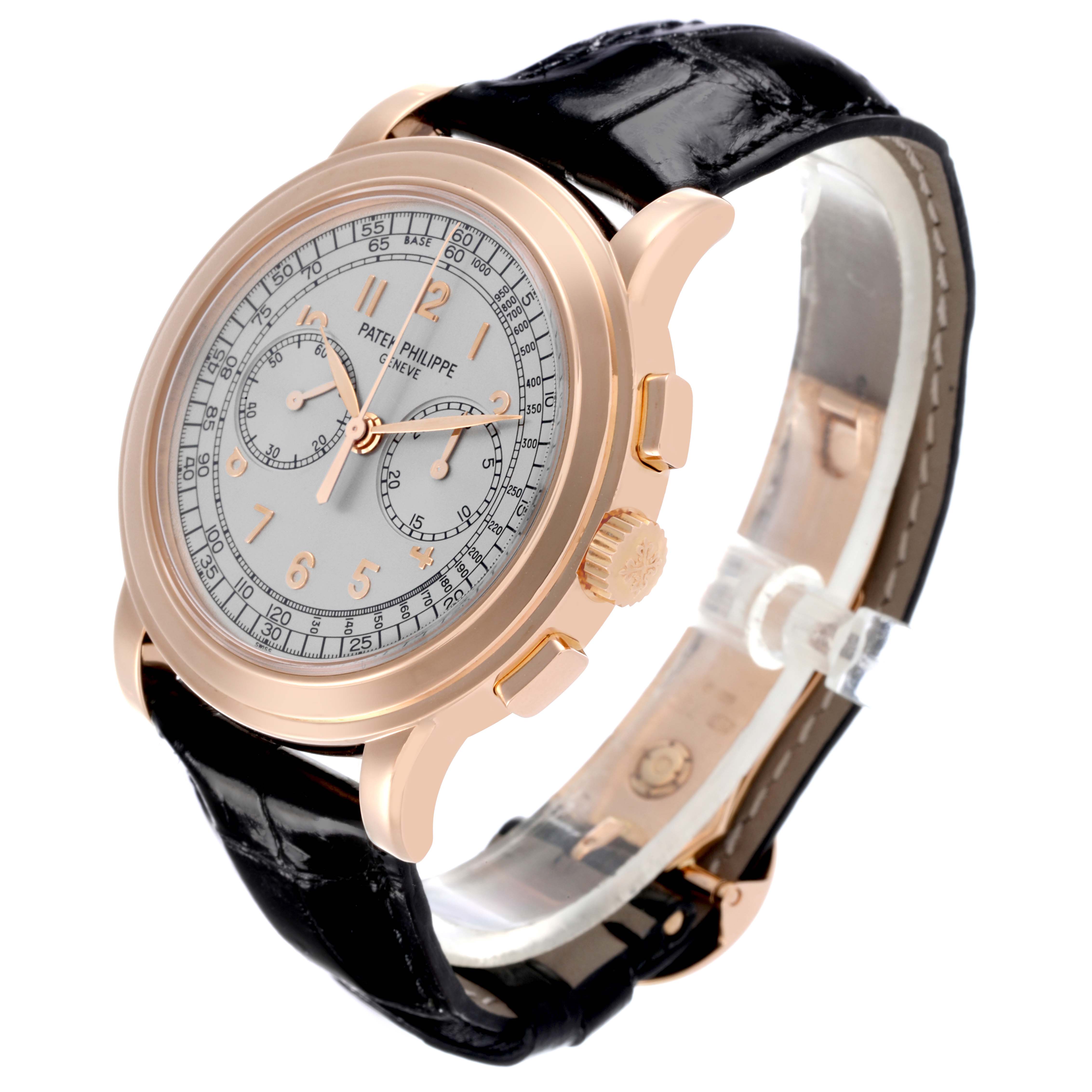 The Patek Philippe Complications 5070R Men's Rose Gold Silver Dial 5070R Men's Rose Gold Silver Dial watch is shown at a slight angle, highlighting its dial, case, crown, and part of the leather strap.
