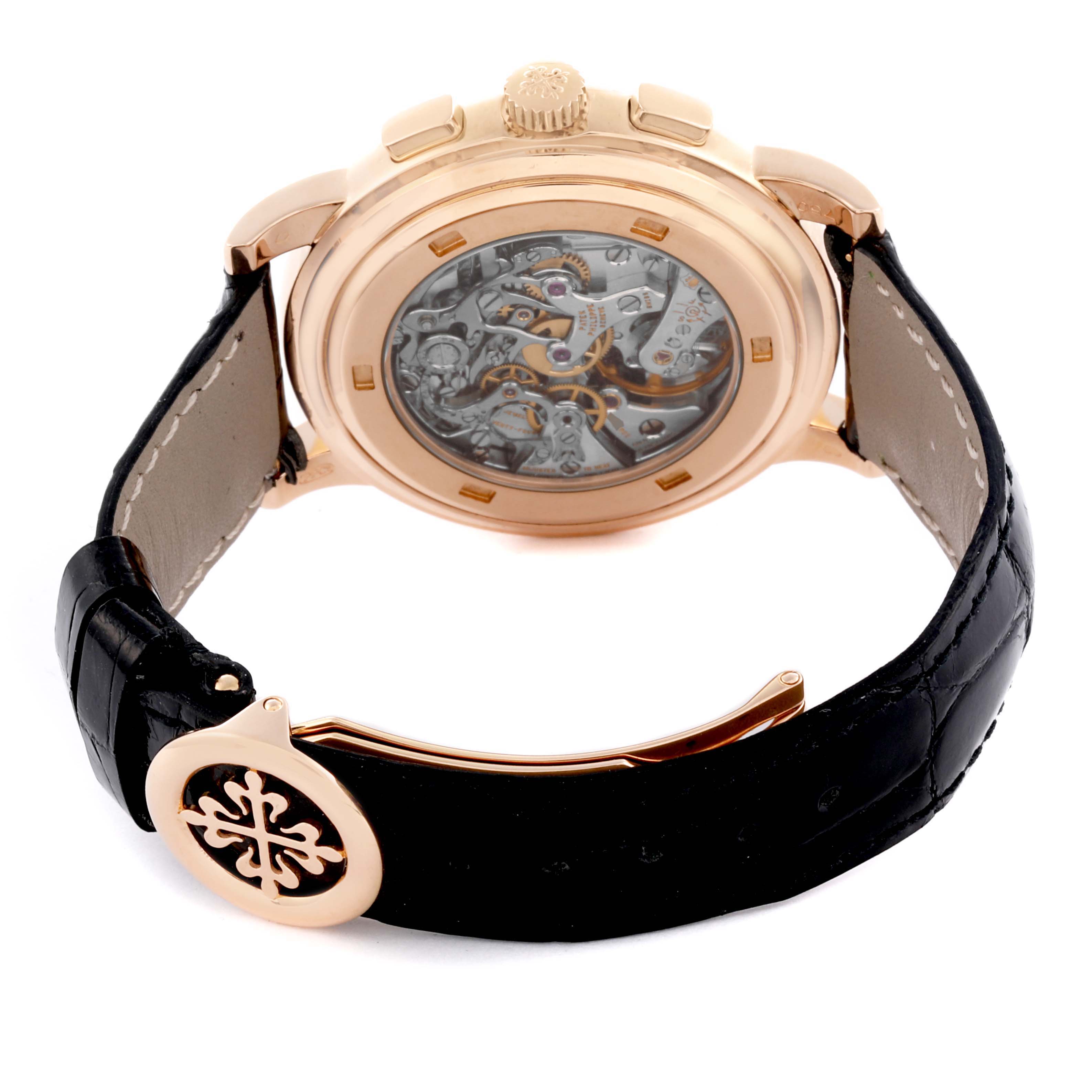 The Patek Philippe Complications 5070R Men's Rose Gold Silver Dial 5070R Men's Rose Gold Silver Dial watch is shown from the back, highlighting the mechanical movement and leather strap.