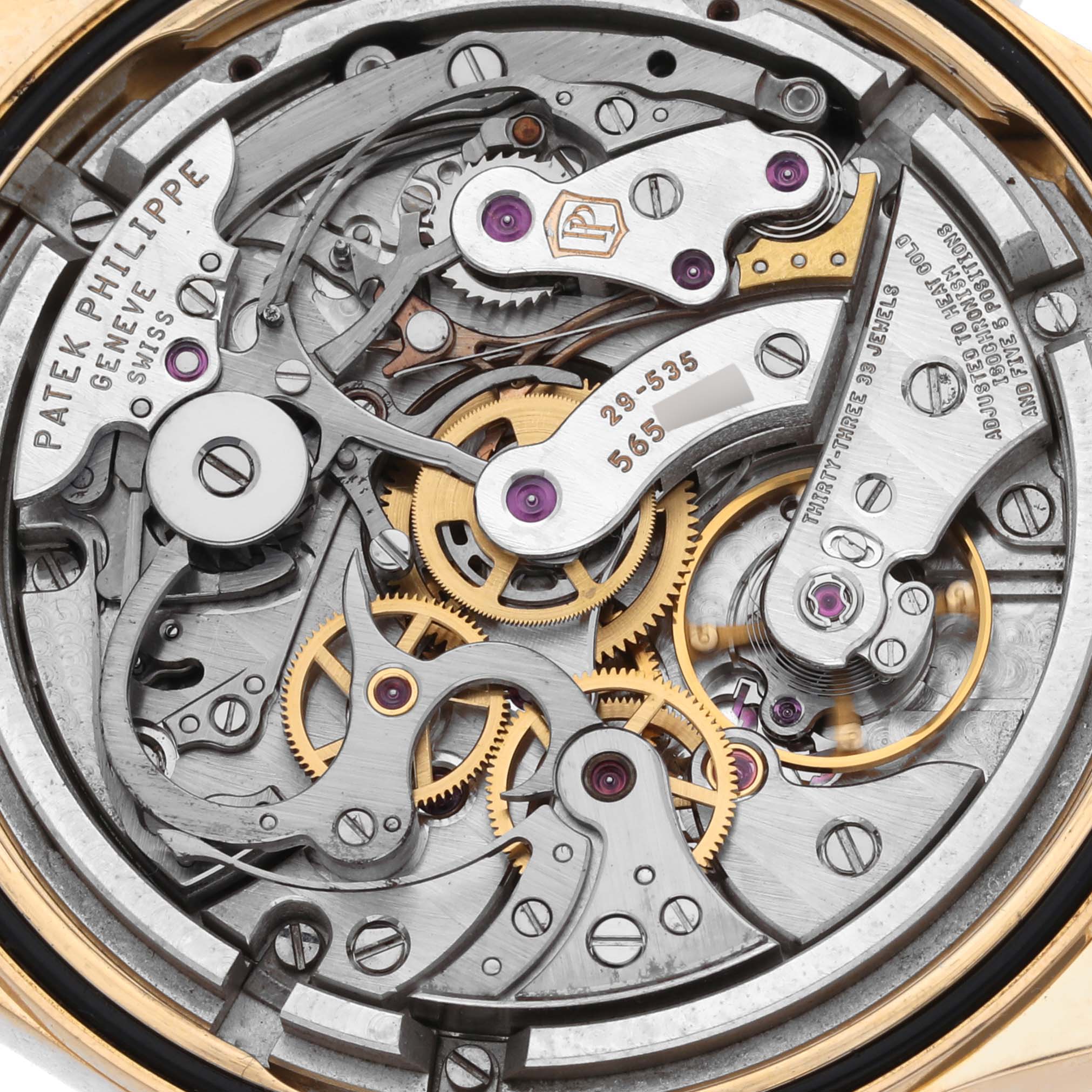 The image shows the intricate movement of a Patek Philippe Complications 5170J Men's Yellow Gold Silver Dial 5170J Men's Yellow Gold Silver Dial watch from a close-up, rear angle.