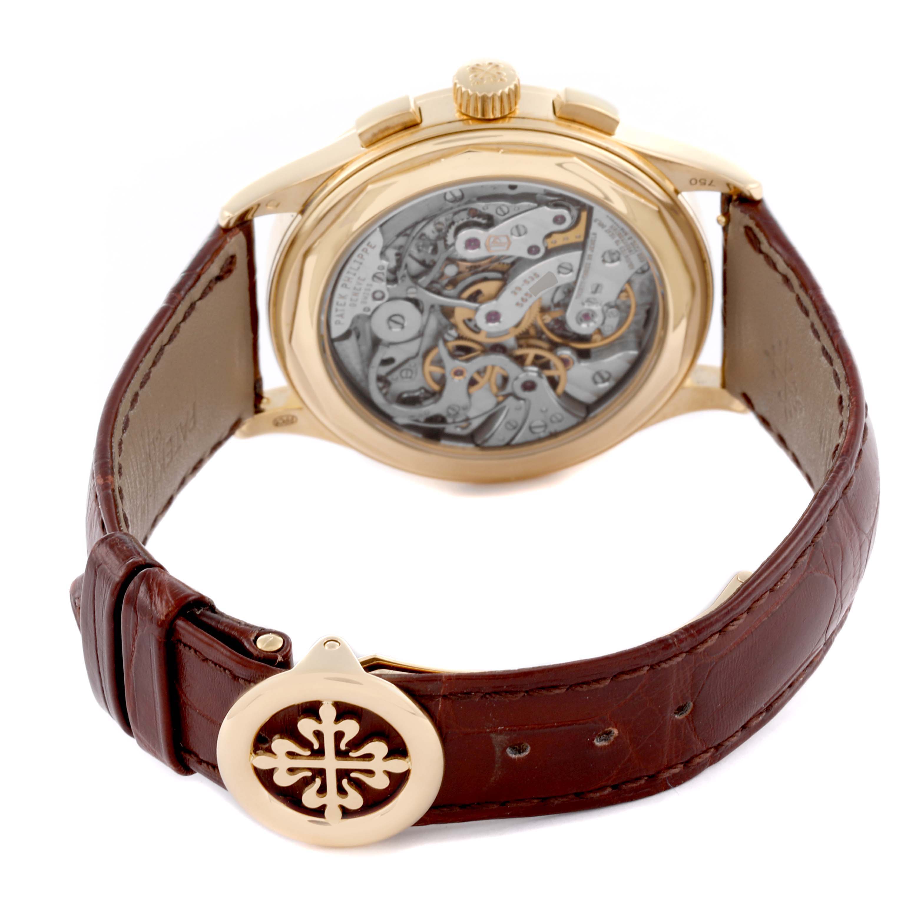 The Patek Philippe Complications 5170J Men's Yellow Gold Silver Dial 5170J Men's Yellow Gold Silver Dial watch is shown from the back, highlighting its intricate movement and leather strap.