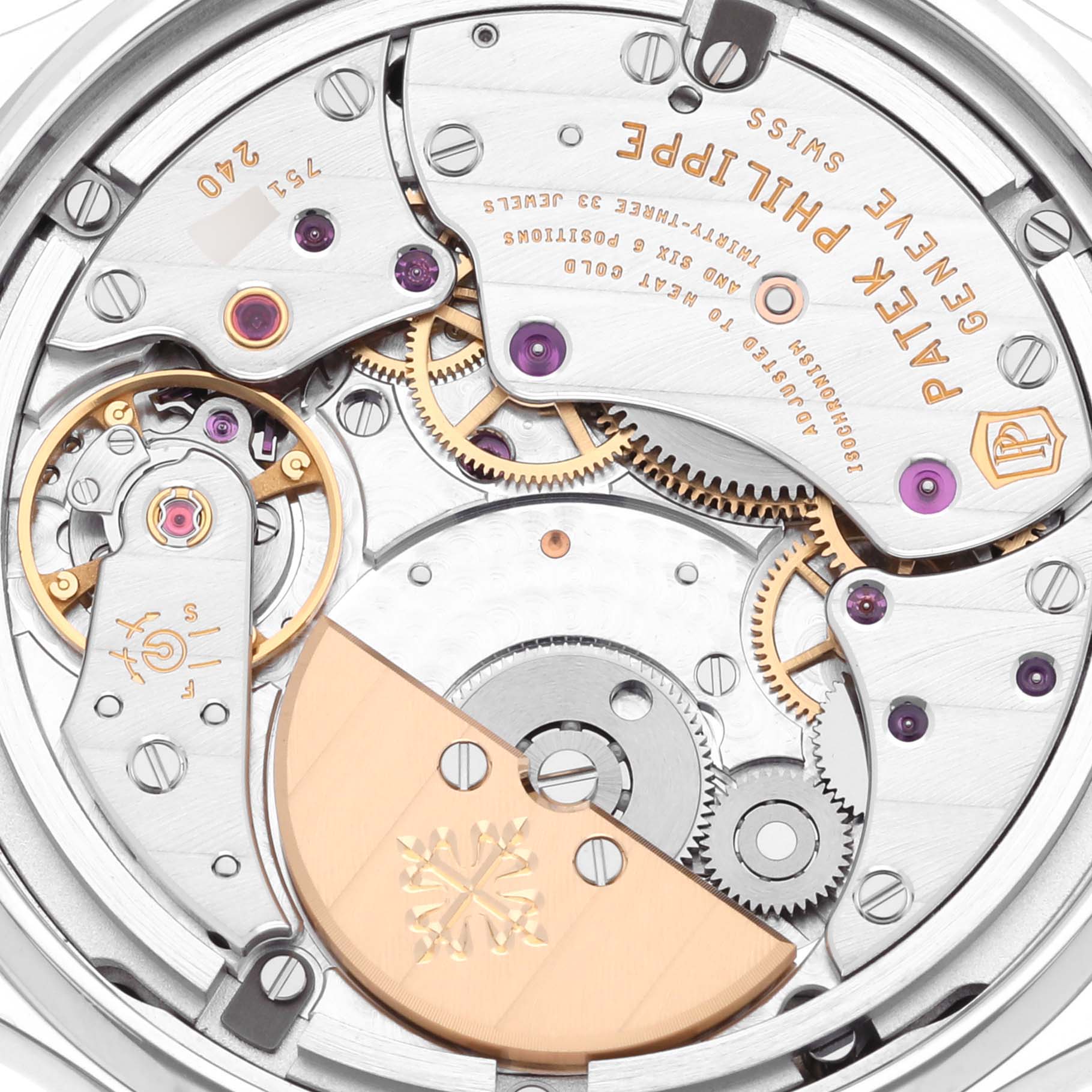 The image shows the intricate movement of the Patek Philippe Complications 7130G-016 Men's White Gold Blue Dial 7130G-016 Men's White Gold Blue Dial watch from a top-down angle, highlighting gears and components.