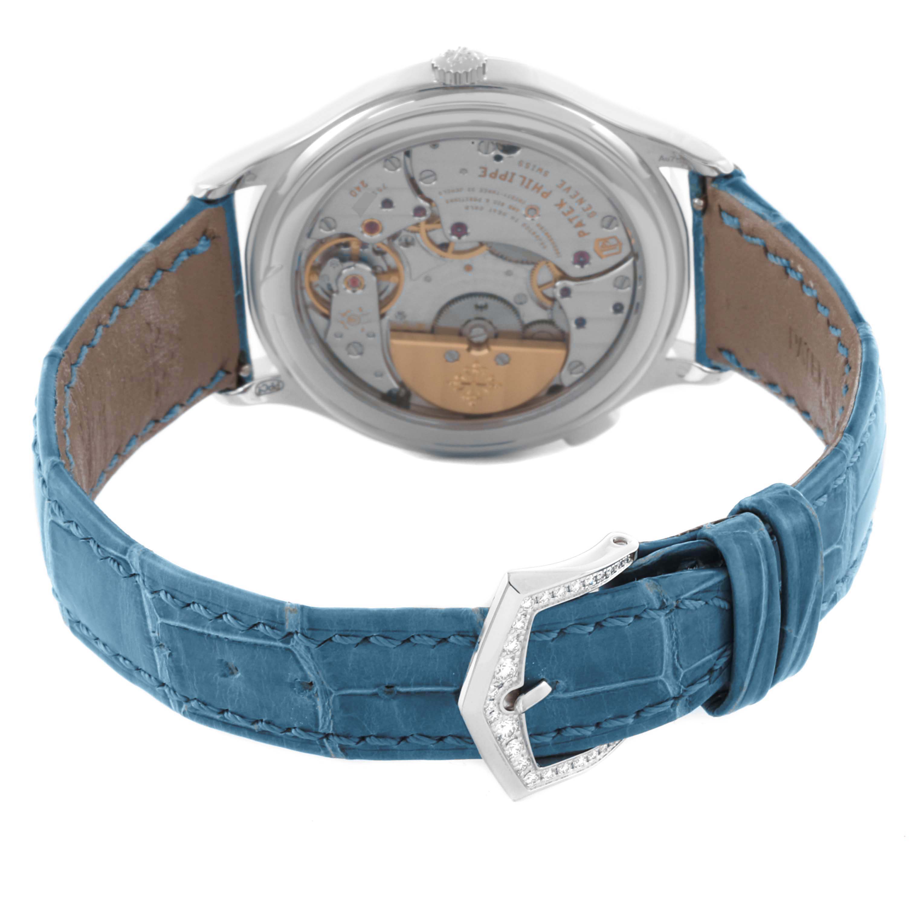 The image shows the back of the Patek Philippe Complications 7130G-016 Men's White Gold Blue Dial 7130G-016 Men's White Gold Blue Dial watch, displaying the movement and blue strap with a jeweled buckle.