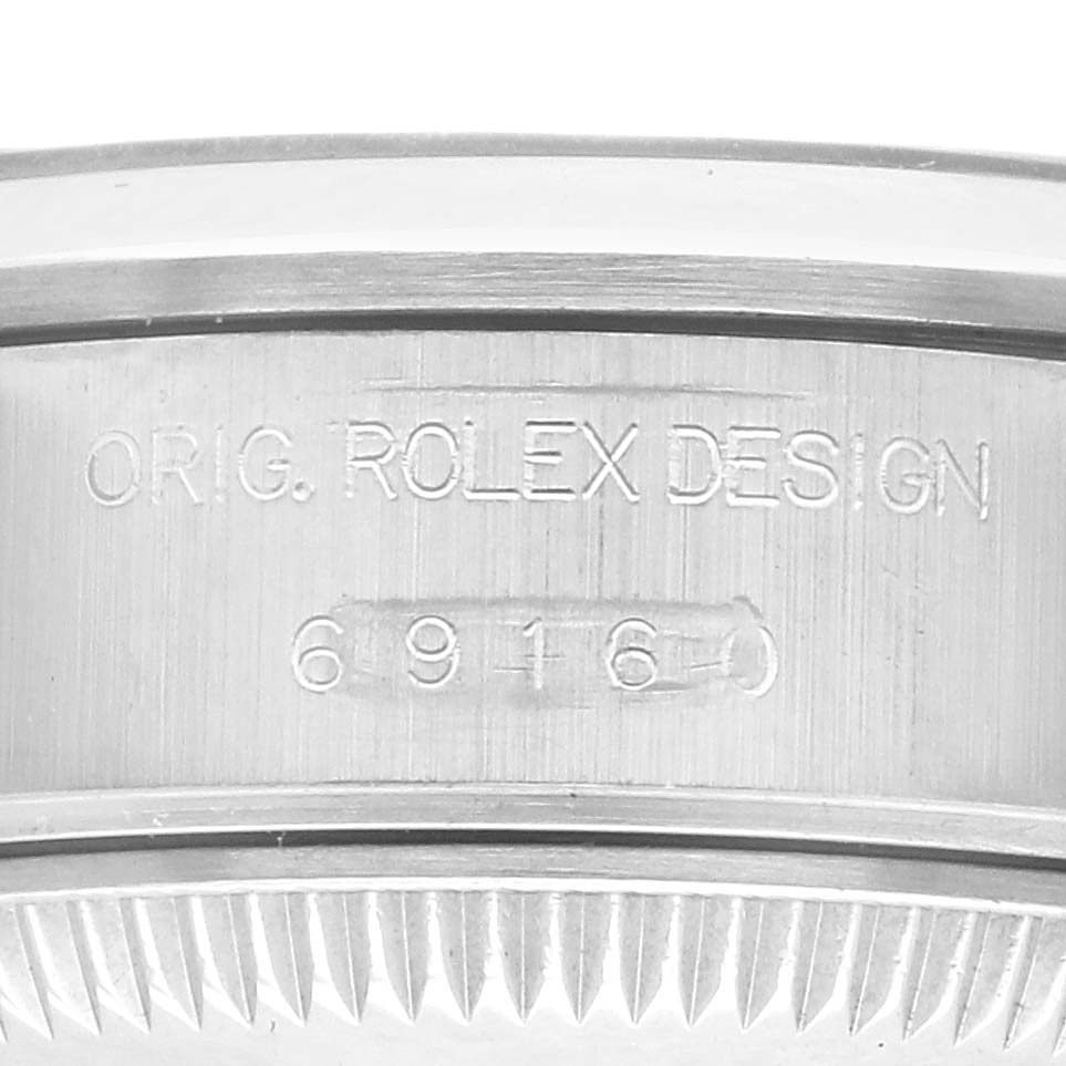 The image shows the side engraving on the case of a Rolex Date 69160 Women's Stainless Steel Black Dial 69160 Women's Stainless Steel Black Dial, highlighting the model number and design details.