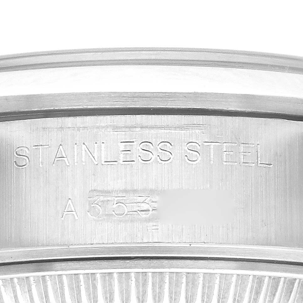 The image shows a close-up of the case side of a Rolex Date 69160 Women's Stainless Steel Black Dial 69160 Women's Stainless Steel Black Dial model, highlighting the "STAINLESS STEEL" engraving.