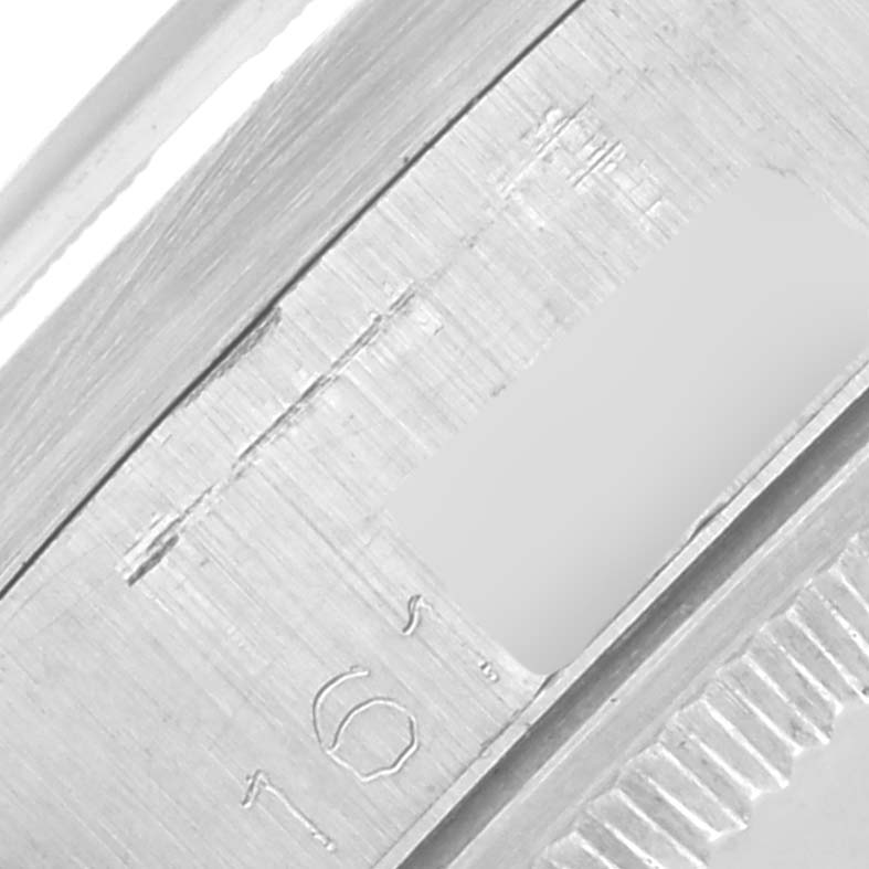 The image shows a close-up of the side and bezel detail of a Rolex Date 1501 Men
s Stainless Steel Silver Dial 1501 Men
s Stainless Steel Silver Dial watch, highlighting etched markings.