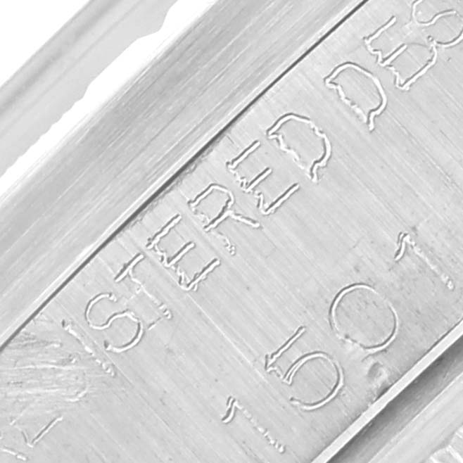 The image shows an engraved side of the Rolex Date 1501 Men
s Stainless Steel Silver Dial 1501 Men
s Stainless Steel Silver Dial model watch case, capturing detail in close-up.