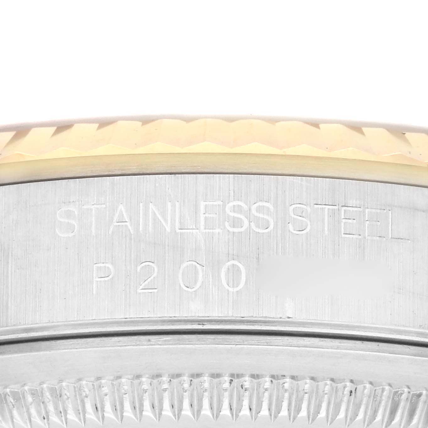 The image shows a close-up side view of the Datejust Rolex bezel and engraving on the case back.