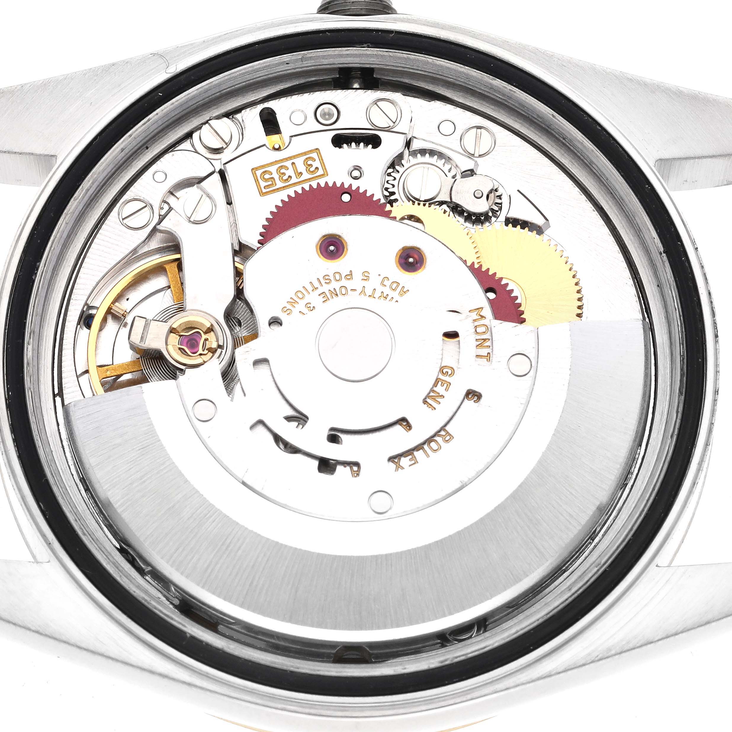 The image shows the movement and inner workings of the Rolex Datejust 16233 Men
s Steel and Gold (two tone) Champagne Dial 16233 Men
s Steel and Gold (two tone) Champagne Dial watch from a back angle.