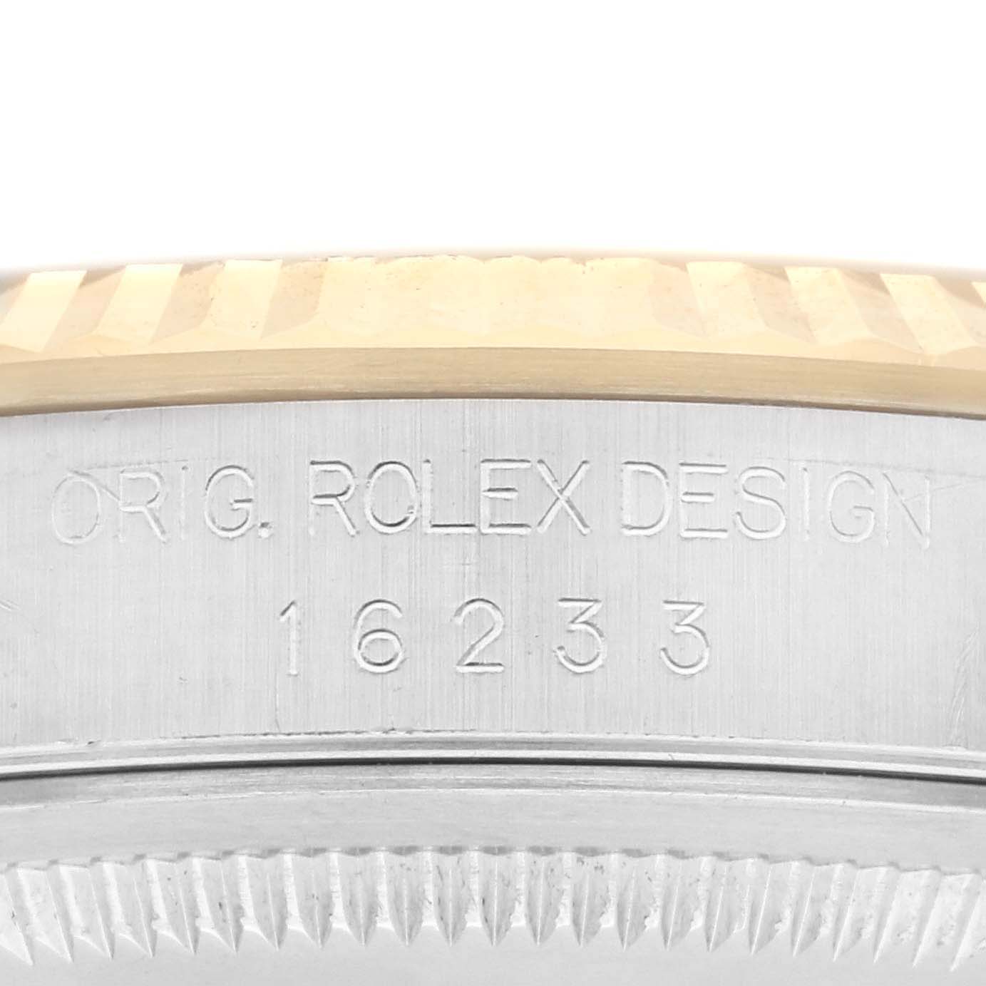 The image shows the side engraving and bezel of a Rolex Datejust 16233 Men
s Steel and Gold (two tone) Champagne Dial 16233 Men
s Steel and Gold (two tone) Champagne Dial, focusing on the model number "16233".