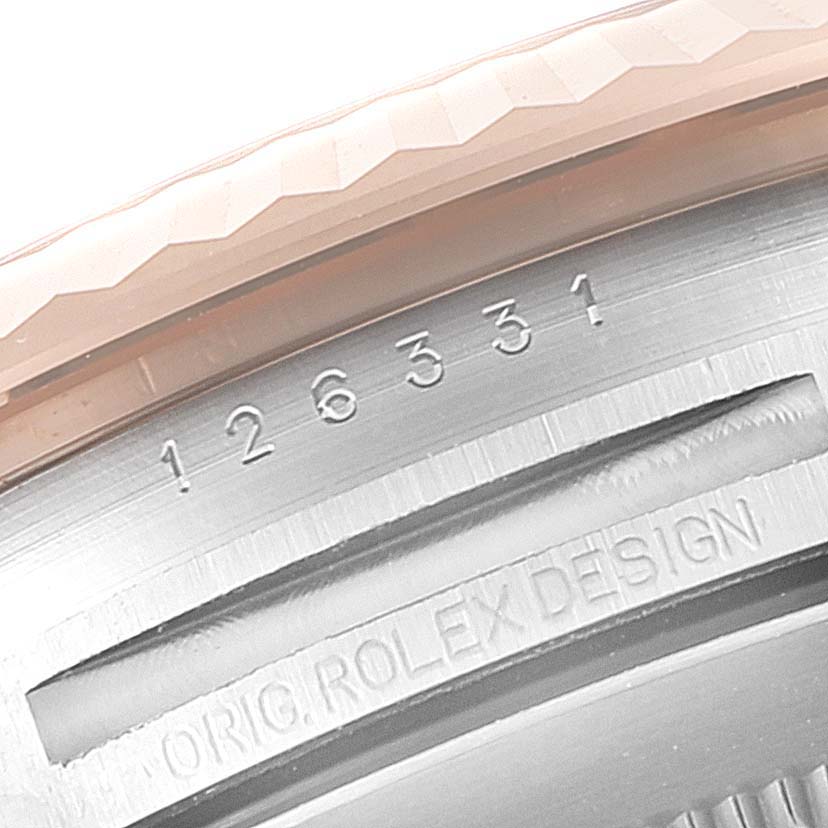 This image shows a close-up of the serial number and "ORIG.ROLEX DESIGN" engraving on the Rolex Datejust 41 126331 Men's Steel and Gold (two tone) Mother of Pearl Dial 126331 Men's Steel and Gold (two tone) Mother of Pearl Dial model.