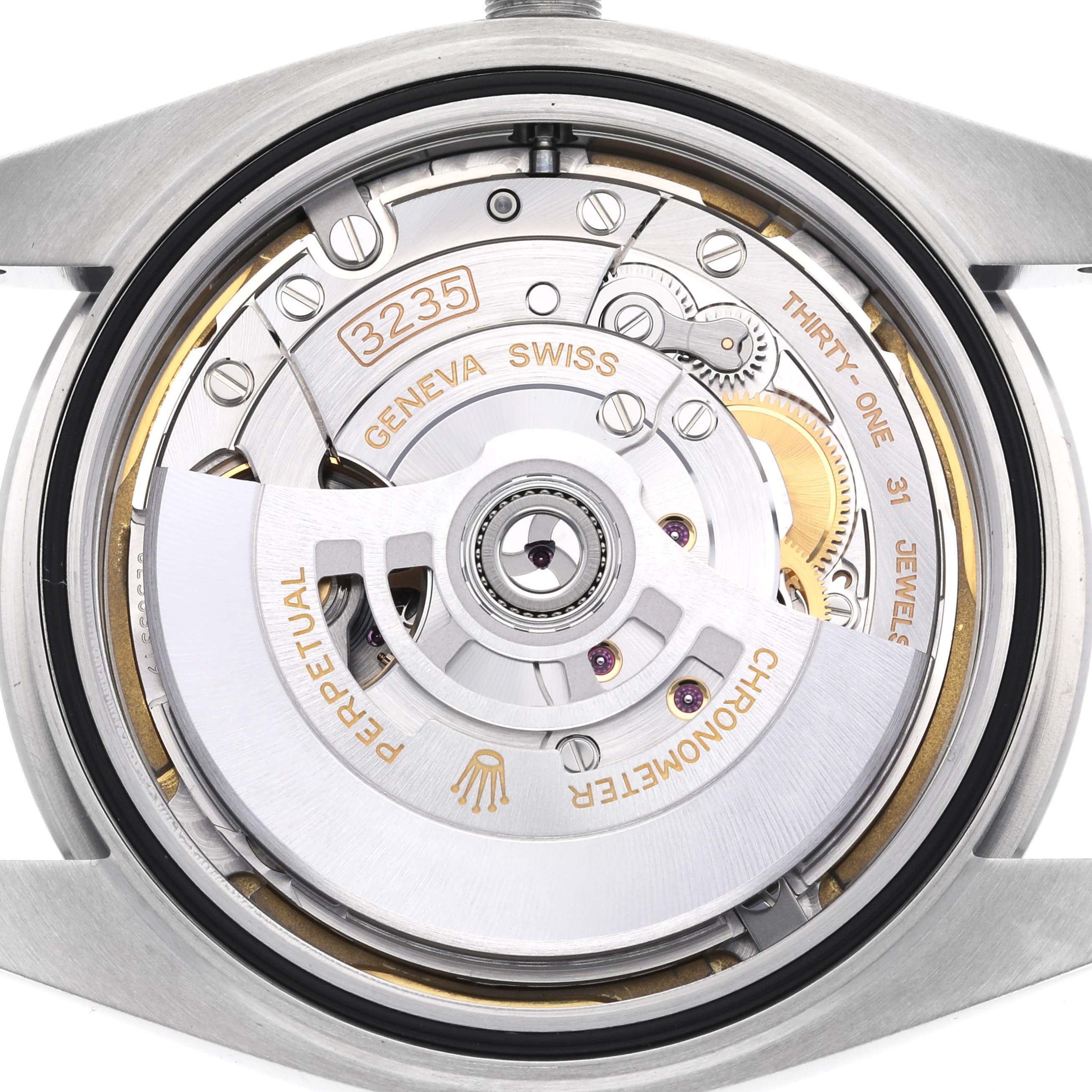 The image shows the movement of a Rolex Datejust 41 126300 Men's Stainless Steel White Dial 126300 Men's Stainless Steel White Dial, focusing on its intricate mechanical parts and rotor.