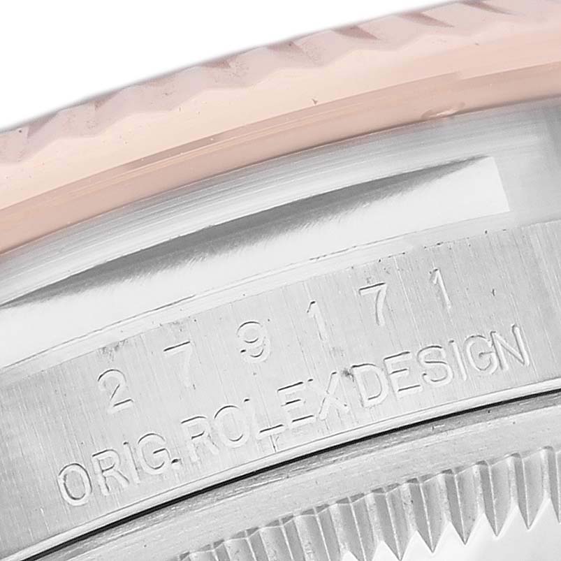 This is a close-up of the Rolex Datejust 279171 Women's Steel and Gold (two tone) Brown Dial 279171 Women's Steel and Gold (two tone) Brown Dial model's side, showcasing the bezel and engraved serial number.