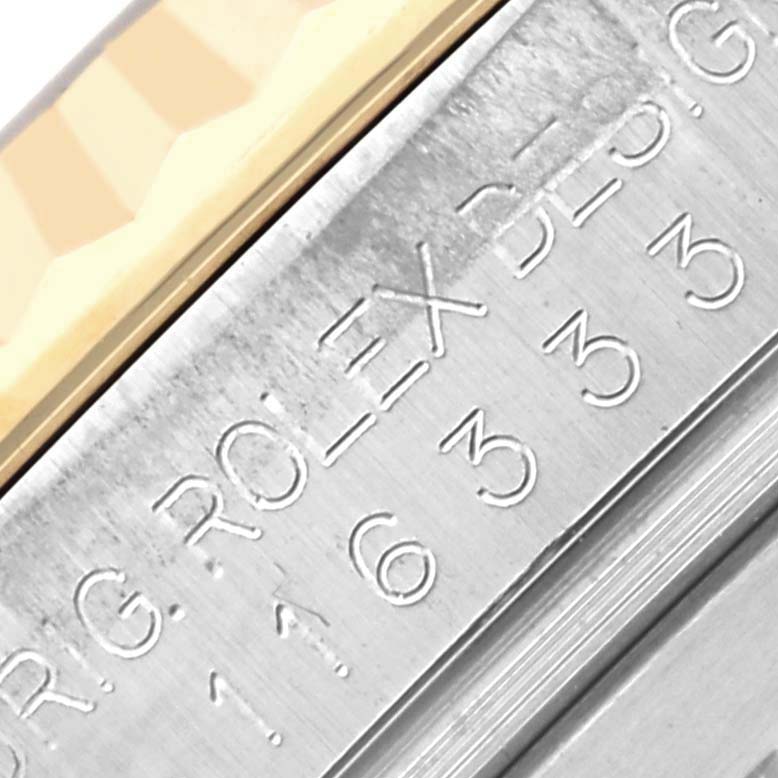 The image shows a close-up of the inner bezel with engravings from the Rolex Datejust 41 116333 Men's Steel and Gold (two tone) Black Dial 116333 Men's Steel and Gold (two tone) Black Dial model.