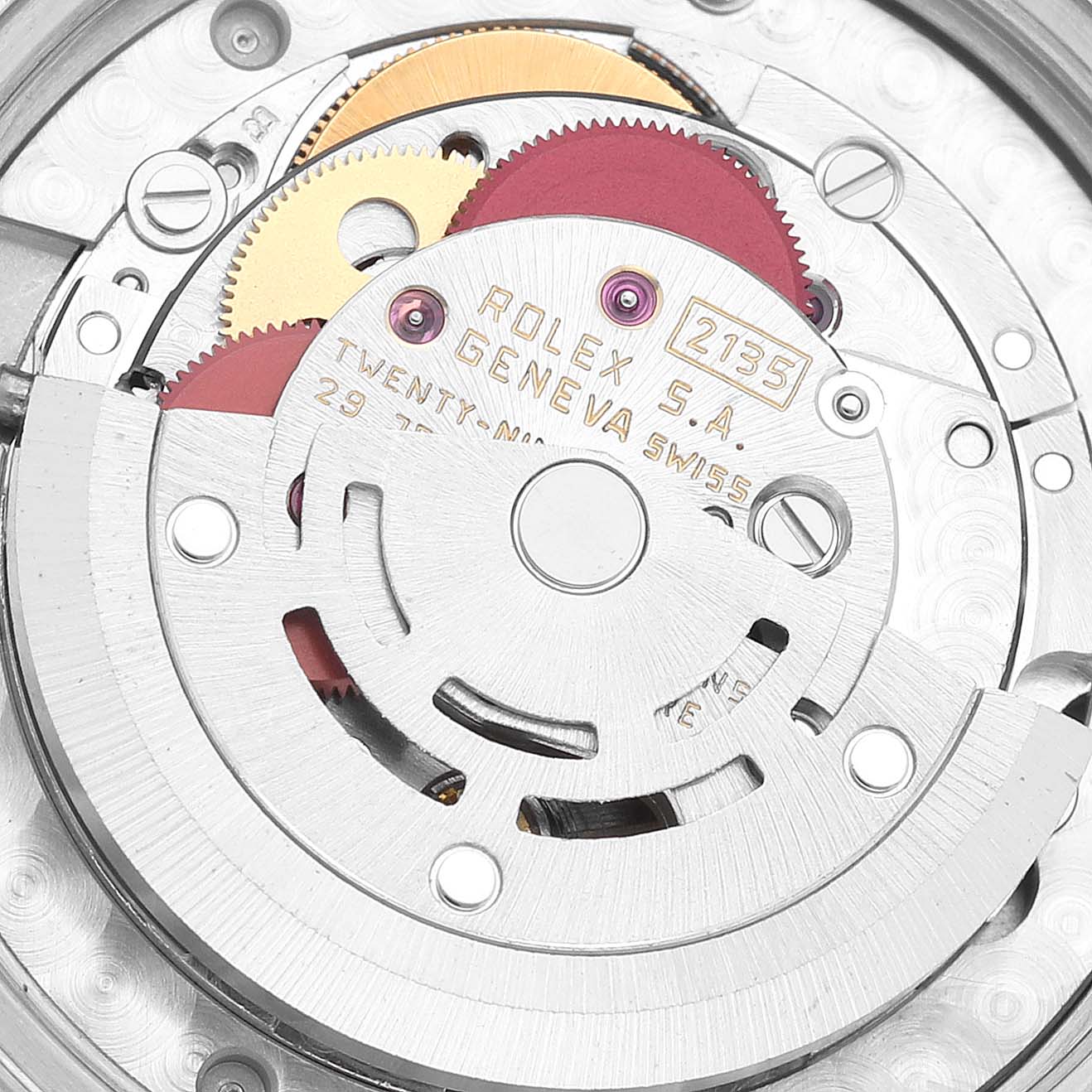 The image shows a close-up of the internal mechanism of a Rolex Mid-Size 68273 Women
s Steel and Gold (two tone) Champagne Dial 68273 Women
s Steel and Gold (two tone) Champagne Dial watch, highlighting the gears and engravings.