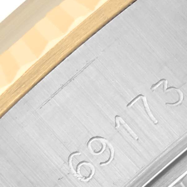 This image shows a close-up of the Rolex Datejust 69173 Women's Steel and Gold (two tone) Champagne Dial 69173 Women's Steel and Gold (two tone) Champagne Dial model's watch case edge with the reference number "69173" engraved.