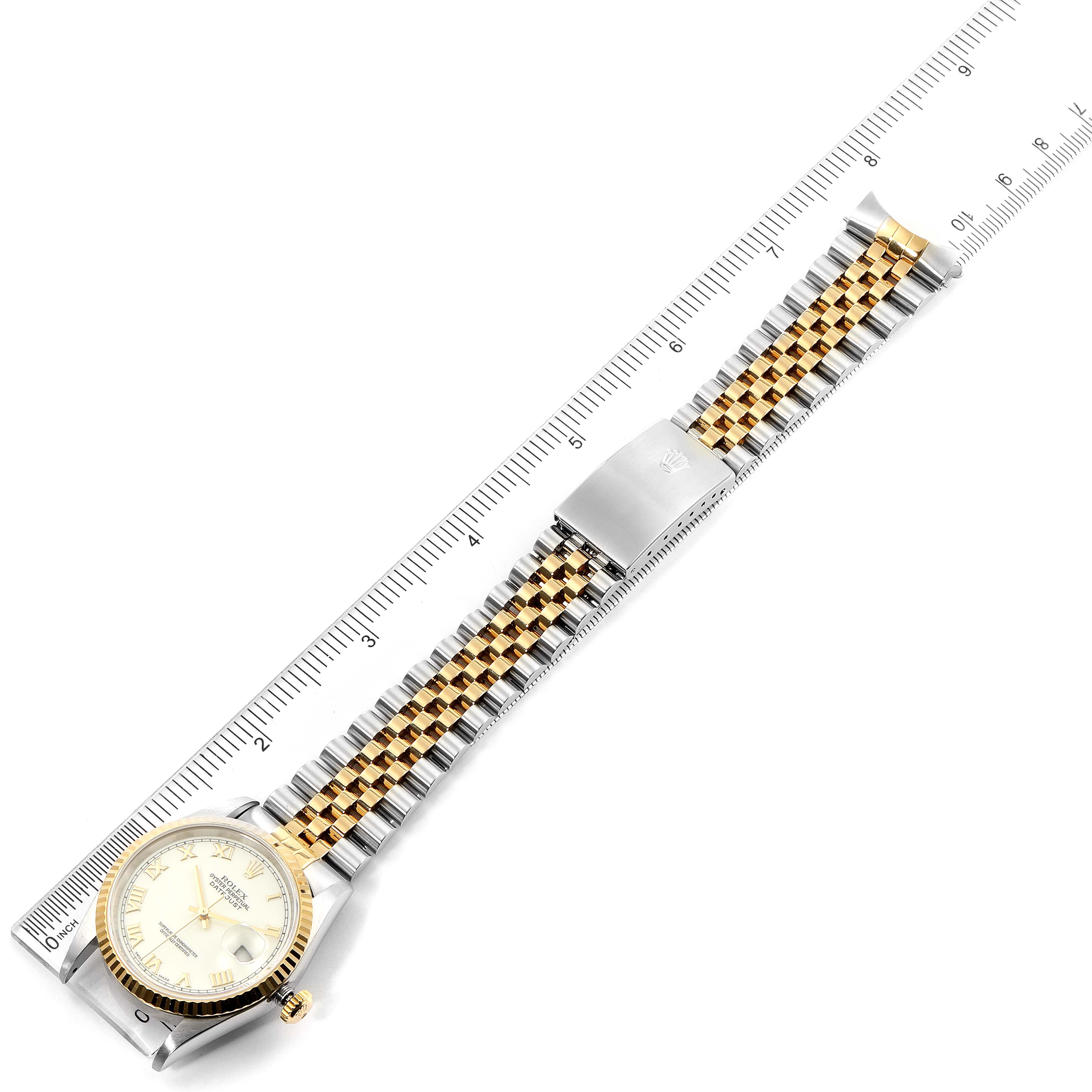 The image shows the Rolex Datejust 16233 Men's Steel and Gold (two tone) White Dial 16233 Men's Steel and Gold (two tone) White Dial watch laid flat, displaying the watch face, case, and the two-tone bracelet with a ruler beside it.