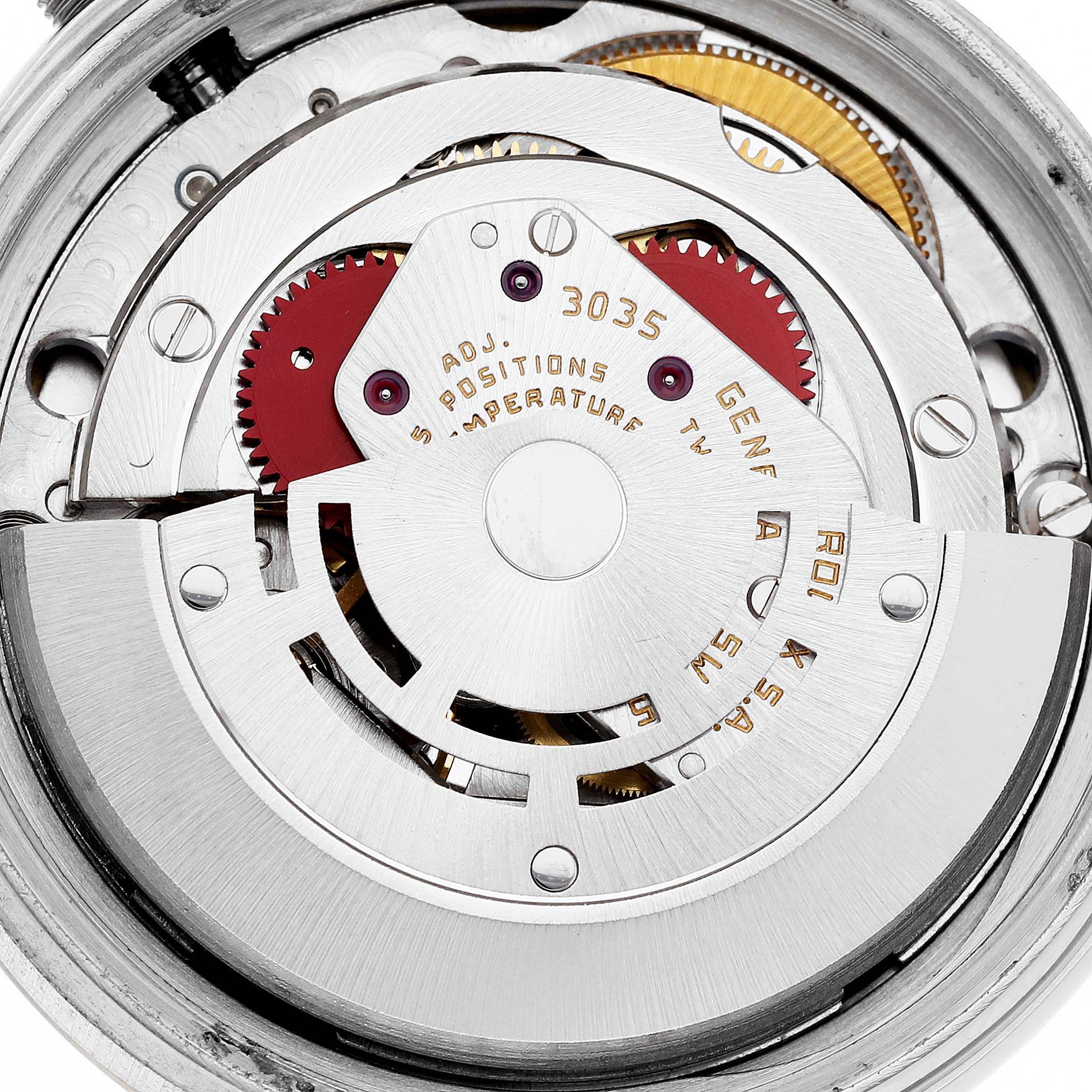 This image shows an overhead view of the movement mechanism of a Rolex Datejust 16013 Men's Steel and Gold (two tone) White Dial 16013 Men's Steel and Gold (two tone) White Dial watch, showcasing the intricate gears and rotor.