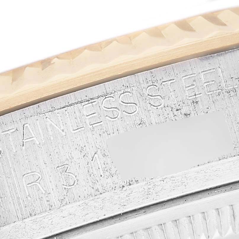 This close-up image shows the engraved bezel and material information on the side of a Rolex Datejust 16013 Men's Steel and Gold (two tone) White Dial 16013 Men's Steel and Gold (two tone) White Dial watch.