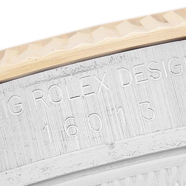 This close-up image shows the engravings on the side of a Rolex Datejust 16013 Men's Steel and Gold (two tone) White Dial 16013 Men's Steel and Gold (two tone) White Dial model, including the serial number and brand.