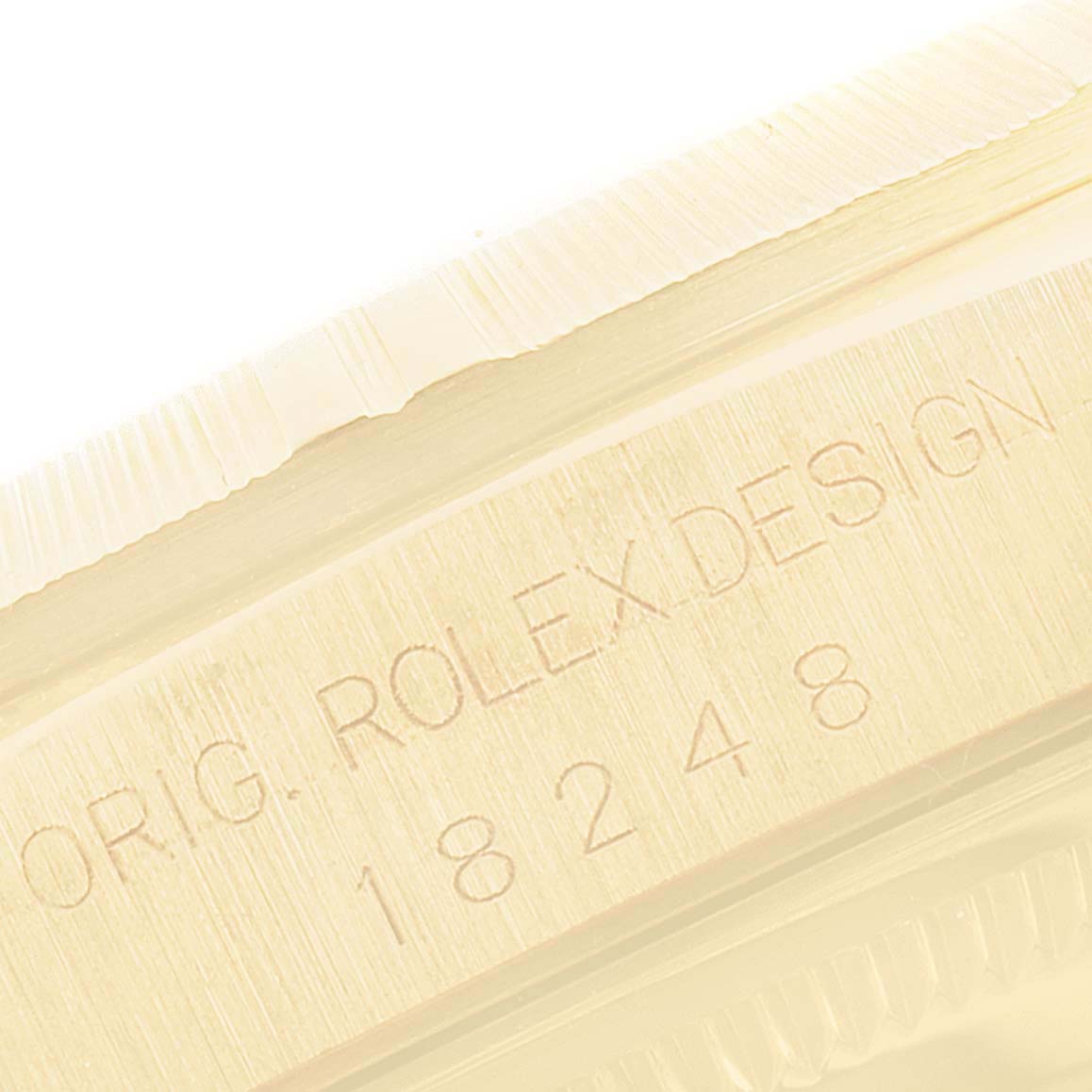 This image shows a close-up of the engraving on the side of the Rolex President 18248 Men's Yellow Gold Silver Dial 18248 Men's Yellow Gold Silver Dial model watch, displaying the serial number and design marking.