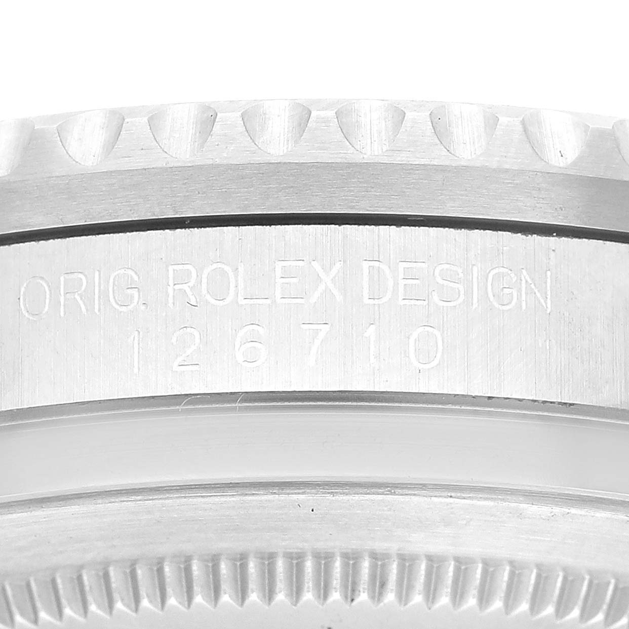 This image shows a close-up of the engraved side and bezel of a Rolex GMT-Master 126710 Men's Stainless Steel Black Dial 126710 Men's Stainless Steel Black Dial model 126710.