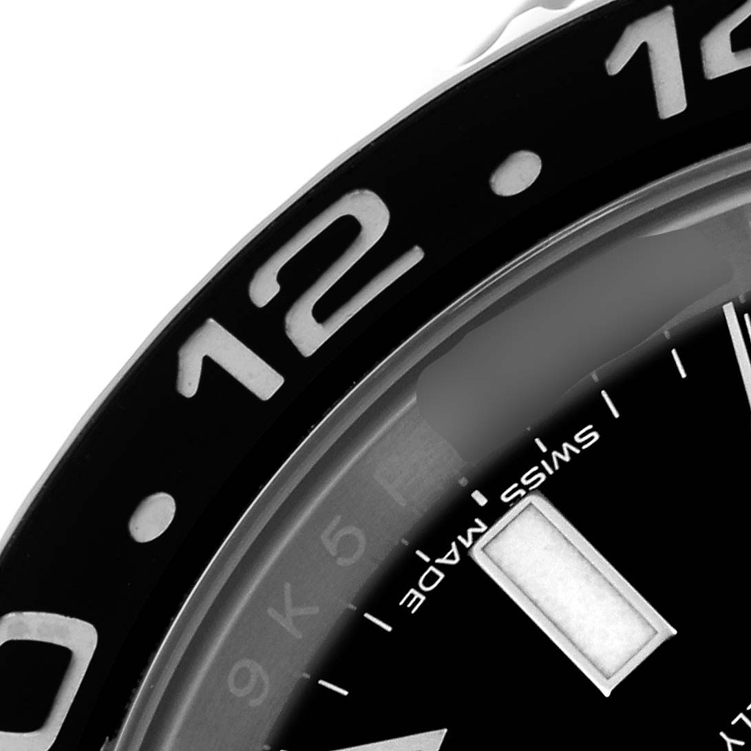 This image shows a close-up of the bezel, part of the dial, and 12 o
clock marker of a Rolex GMT-Master 116710 Men
s Stainless Steel Black Dial 116710 Men
s Stainless Steel Black Dial watch.