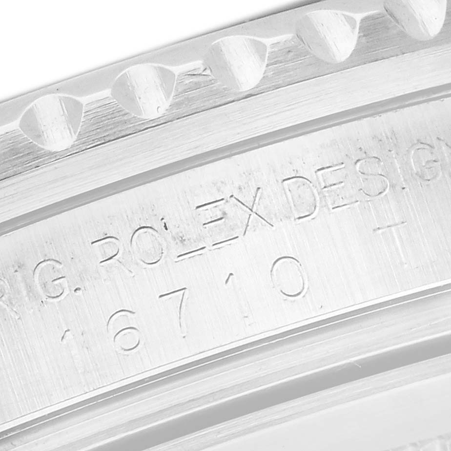 The image shows a close-up of the engraving on the side of the Rolex GMT-Master 16710 Men
s Stainless Steel Black Dial 16710 Men
s Stainless Steel Black Dial 16710
s case.
