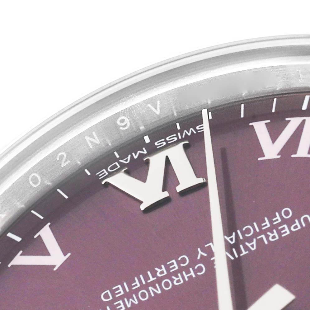 The image shows the partial face and bezel of a mid-size Rolex watch at an oblique angle.